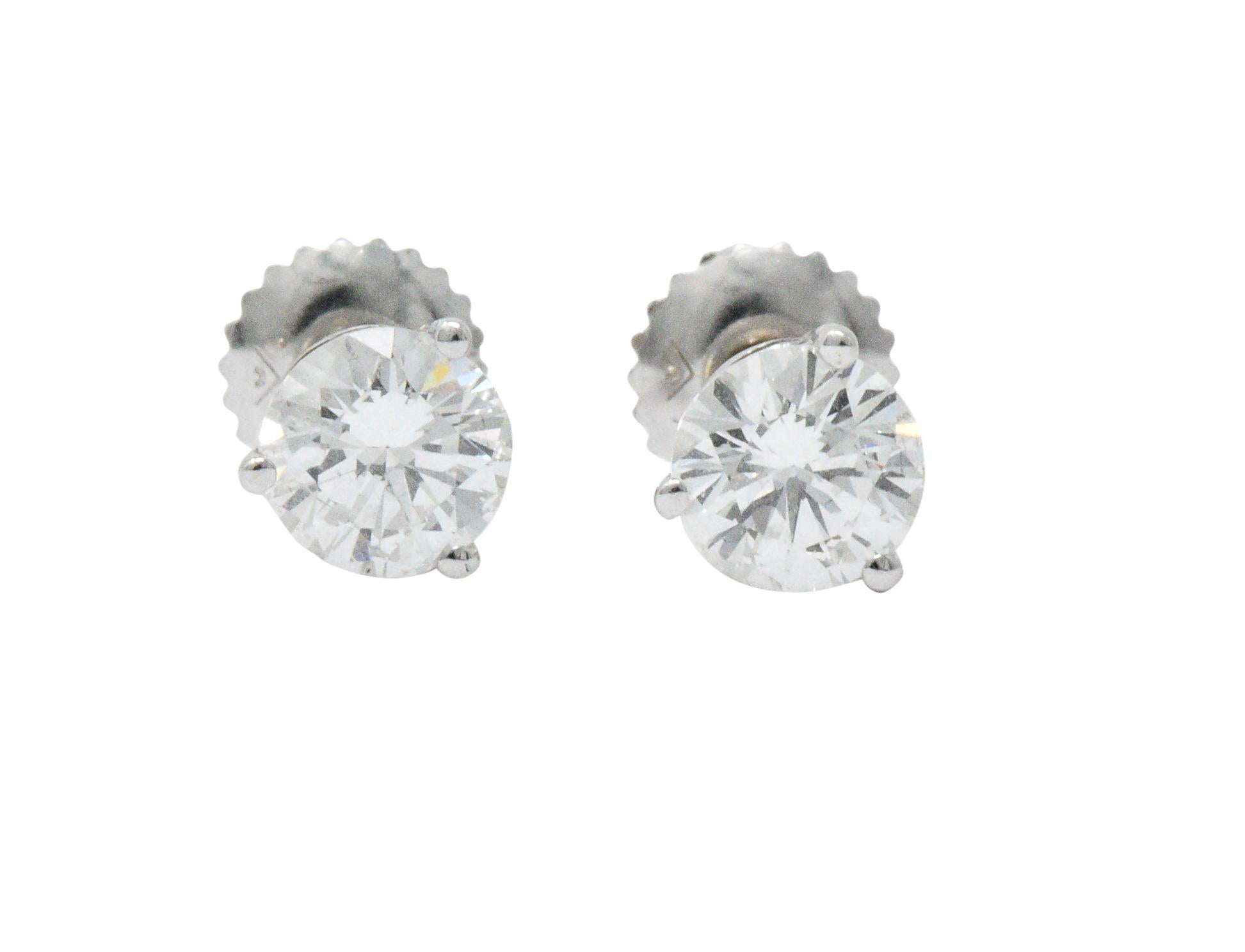 Featuring two round brilliant cut diamonds weighing in total approximately 1.20 carats, I/J color with SI clarity

Set by three prongs as a martini basket style stud earring

Completed by threaded posts and screw backs

Tested as 18 karat