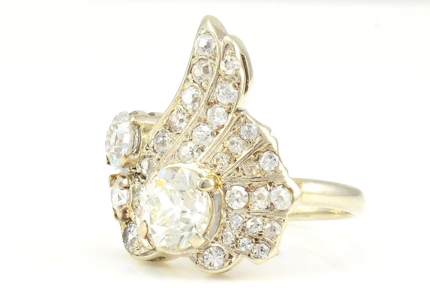 Vintage 14 karat white gold 1.20 carat center diamond cocktail ring, circa 1950. This ring has a center Old European cut diamond at 1.20 carats SI2 clarity L color, one Old European cut accent diamond at 0.45 carat SI2 clarity H color and 29 accent
