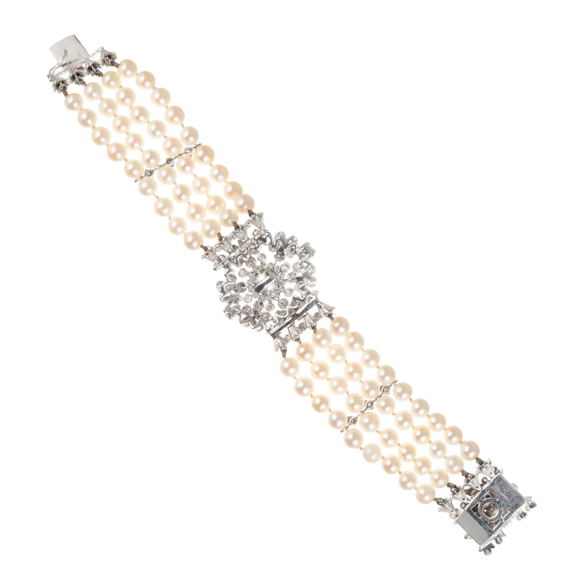 Vintage 1950's four row cultured pearl bracelet with a diamond and pearl center and a diamond and pearl catch. Diamond spacers and white gold case. 7 inches long. 

72 cultured white with crème color pearls, 5.5mm
6 cultured white with crème color