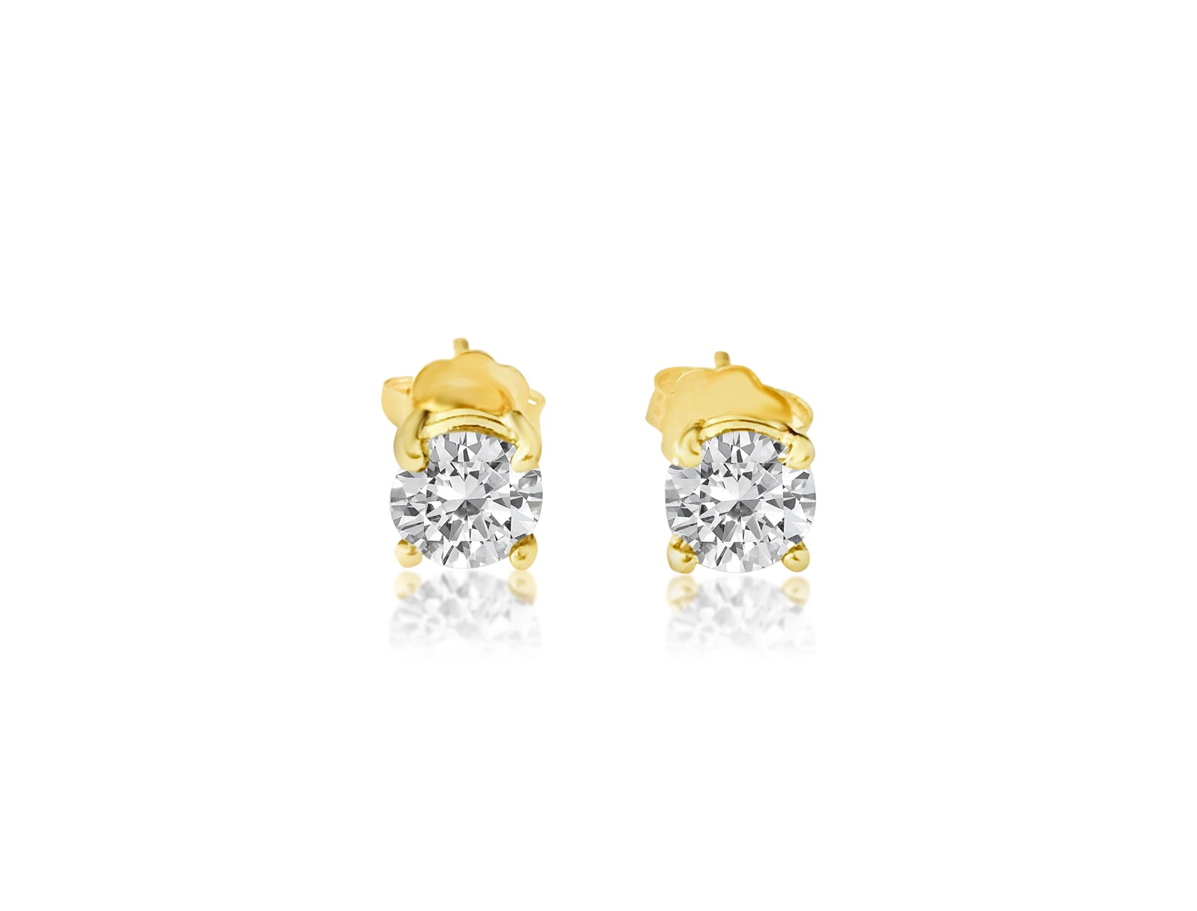 Round Cut 1.20 carat diamond studs in 14kt yellow gold. Custom piece For Sale