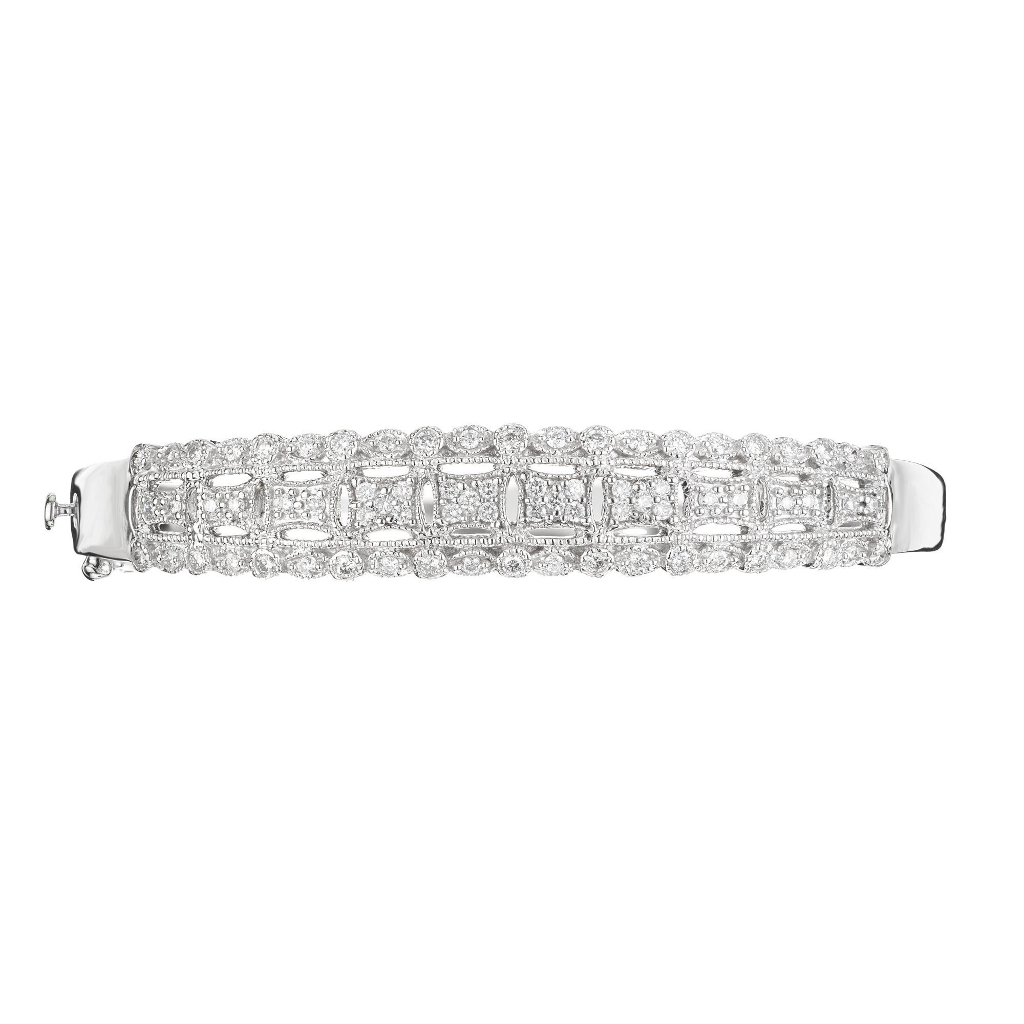 Diamond bangle bracelet. This mid-century 1960's bracelet consists of 74 round full cut diamonds totaling 1.20cts.  Highly detailed and open work, 14k white gold bracelet. This is a hinge bangle making it easier to put on. 

74 round full cut