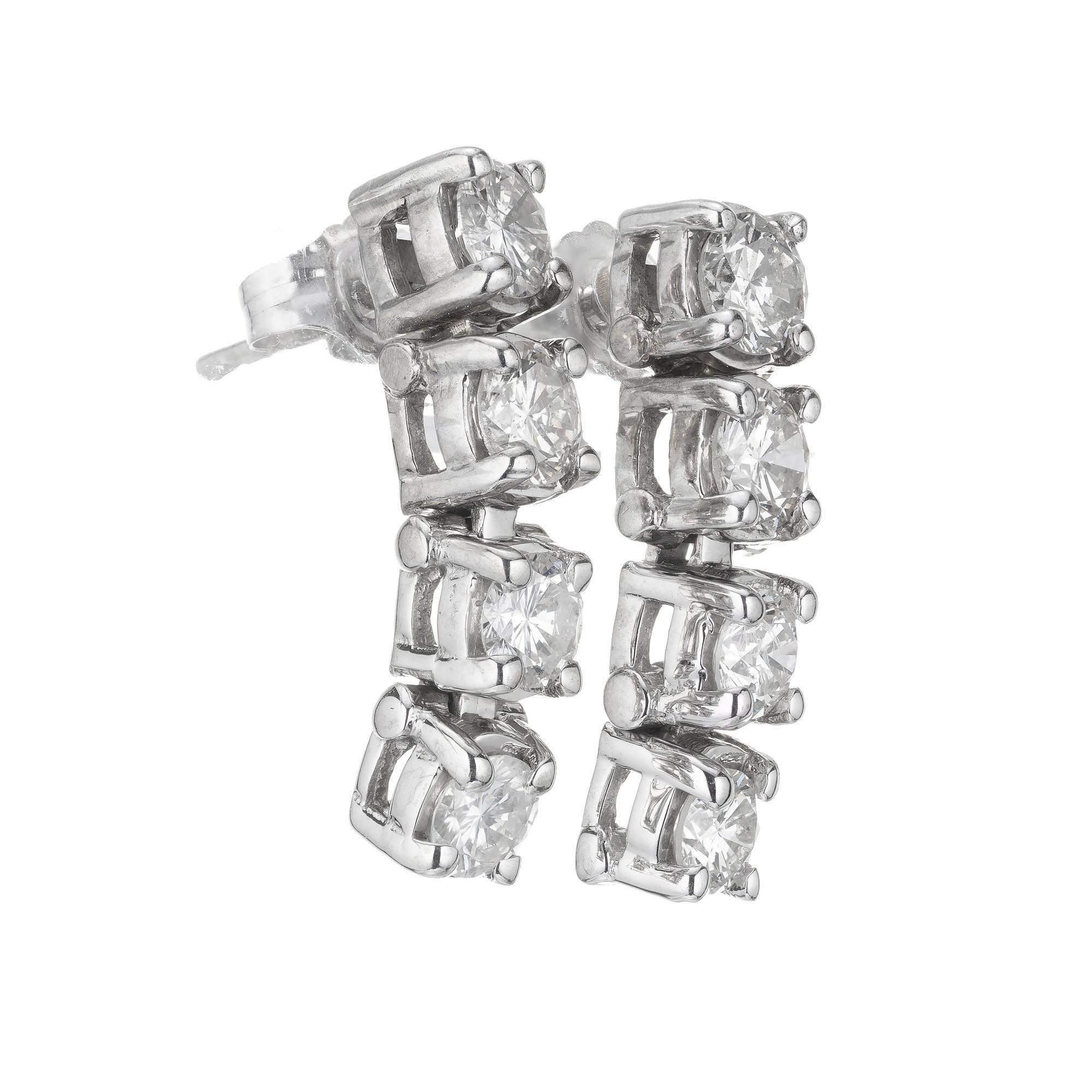 Four diamond dangle hinged dangle earrings, in 14k white gold. 

8 round brilliant cut diamonds I-J SI, approx. 1.20cts
14k white gold
Tested: 14k 
4.2 grams
Top to bottom: 19mm or .75 Inch
Width: 5.25mm
