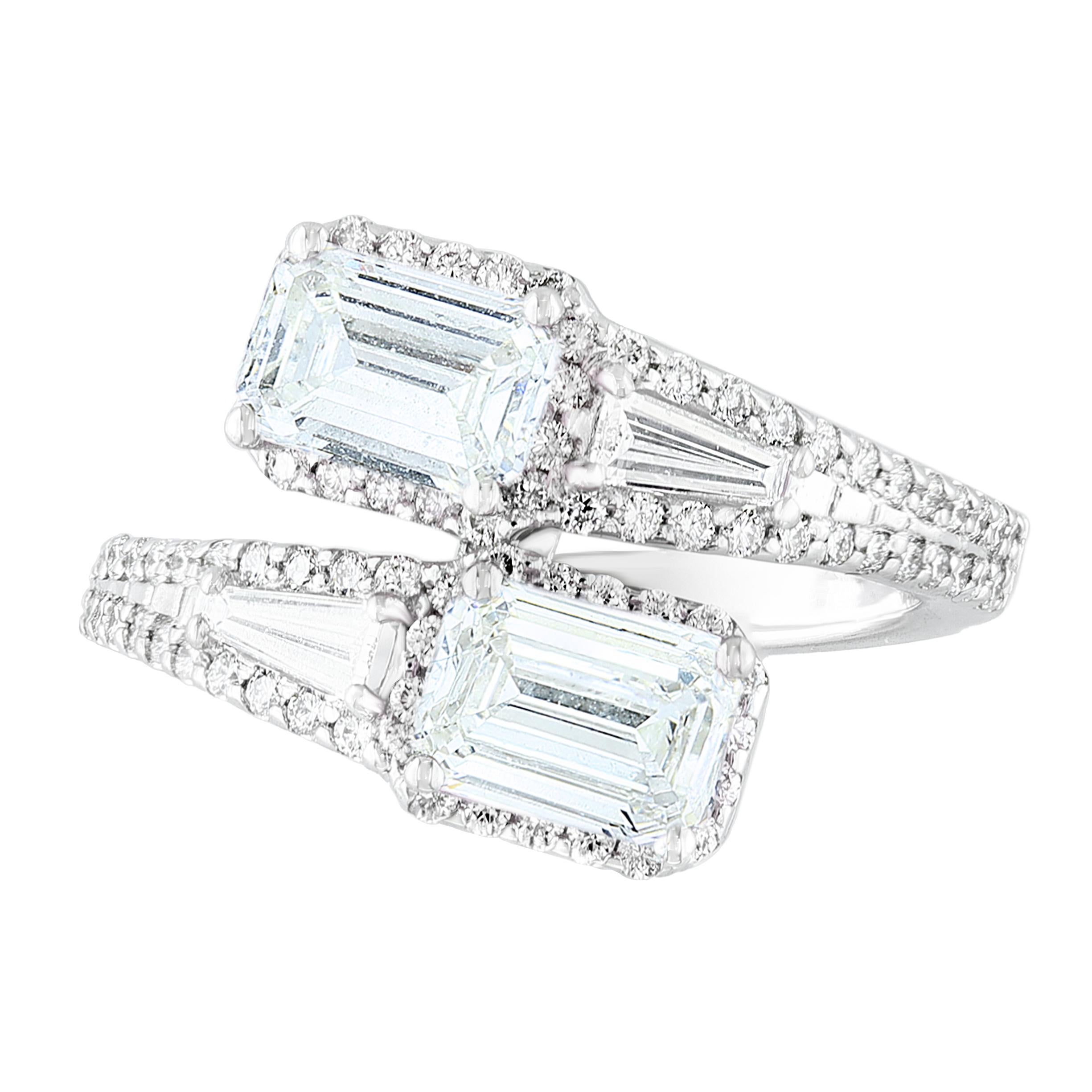 The stunning forever-together Toi et Moi ring features 2 Emerald cut Diamonds embraced by east to west 2 baguette diamonds weigh and 84 round diamonds halfway to the shank. Handcrafted in 14k White Gold.
2 emerald cut Diamonds in the center weigh
