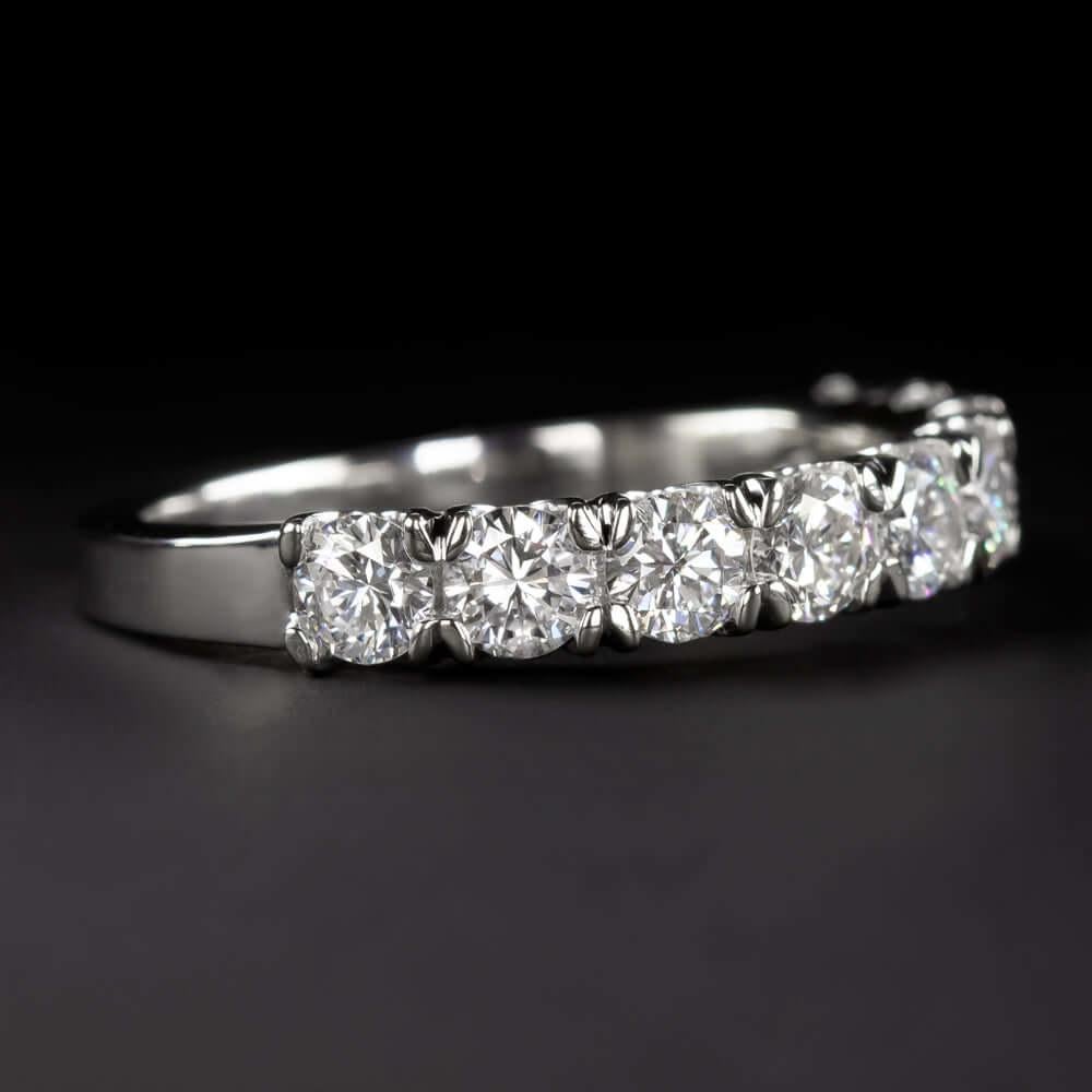This eye catching, elegant, and high quality wedding band has a stunning display of vibrant sparkle! 
This is an extremely high quality ring from stone quality to metal and craftsmanship. Graded F-G VS, the 9 round brilliant cut diamonds are