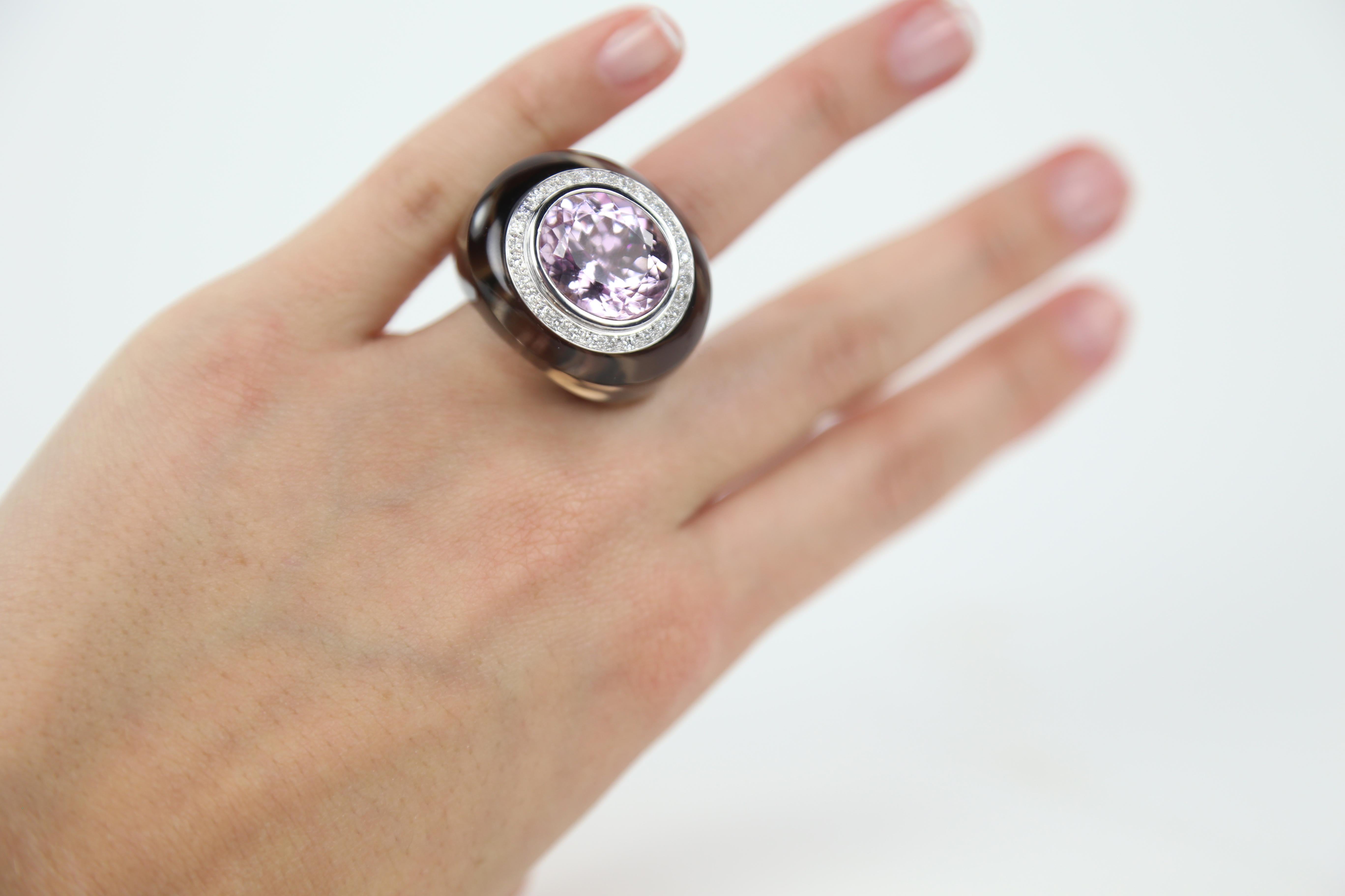 A Show Stopper! Stylish and finely detailed Ring featuring an oval shaped natural pastel purplish pink Kunzite; approx. 12ct. (16mm x 13.5mm) surrounded by 0.40 Carats of Diamonds; enveloped in smoky quartz; unique stunning design, hand crafted in