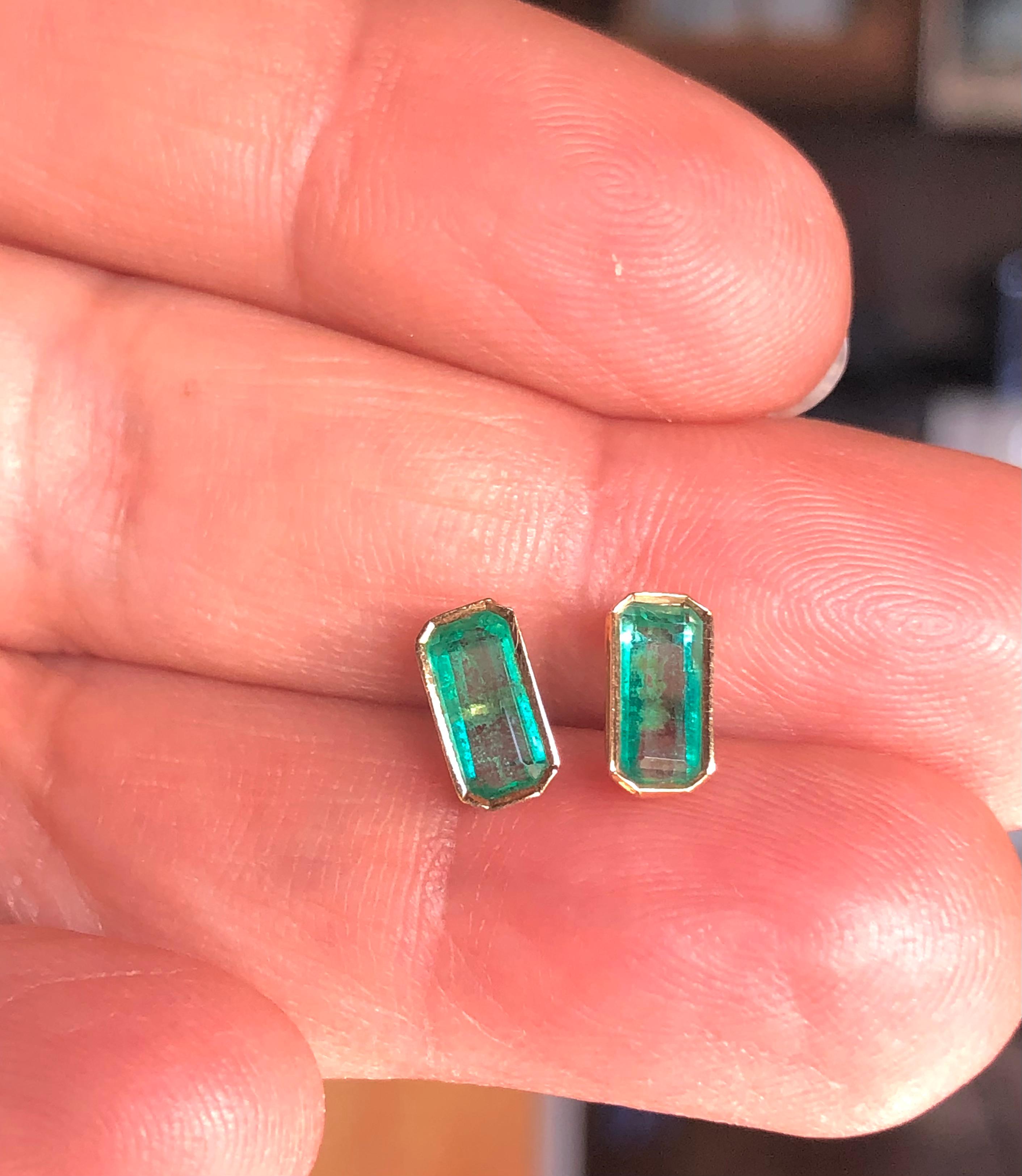 Stylish everyday natural Colombian emerald elongate stud earrings 18K Yellow gold 
Primary Stones: 100% Natural Colombian Emerald 
Shape or Cut: Elongate Emerald Cut 
Average Color/Clarity: Light Medium Green/ Clarity, VS 
Weight Emeralds: Approx.