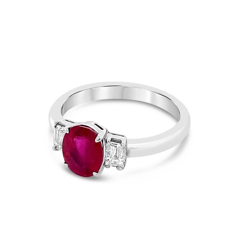 This ring features a beautiful 1.20 carat oval cut ruby surrounded by 0.30 carat total weight in two emerald cut diamonds set in platinum. This ring is currently a size 5.5 but can be resized upon request.
