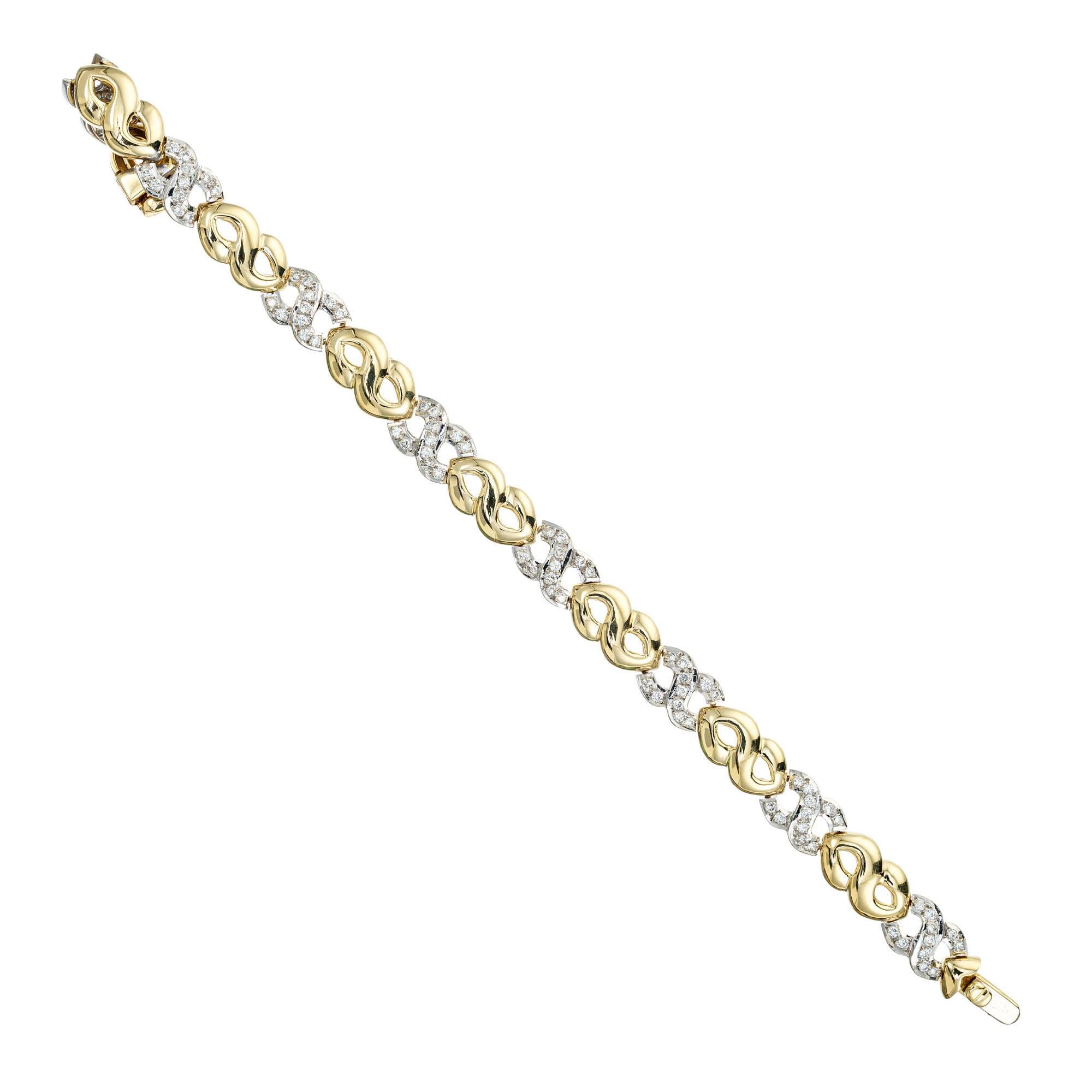 Pave diamond gold bracelet. 88 round full cut pave set diamonds set in 18k white gold swirl links, connected by 18k yellow swirl links. 7.5 inches in length. Built in hidden catch and underside safety.

88 round full cut diamonds approx. total