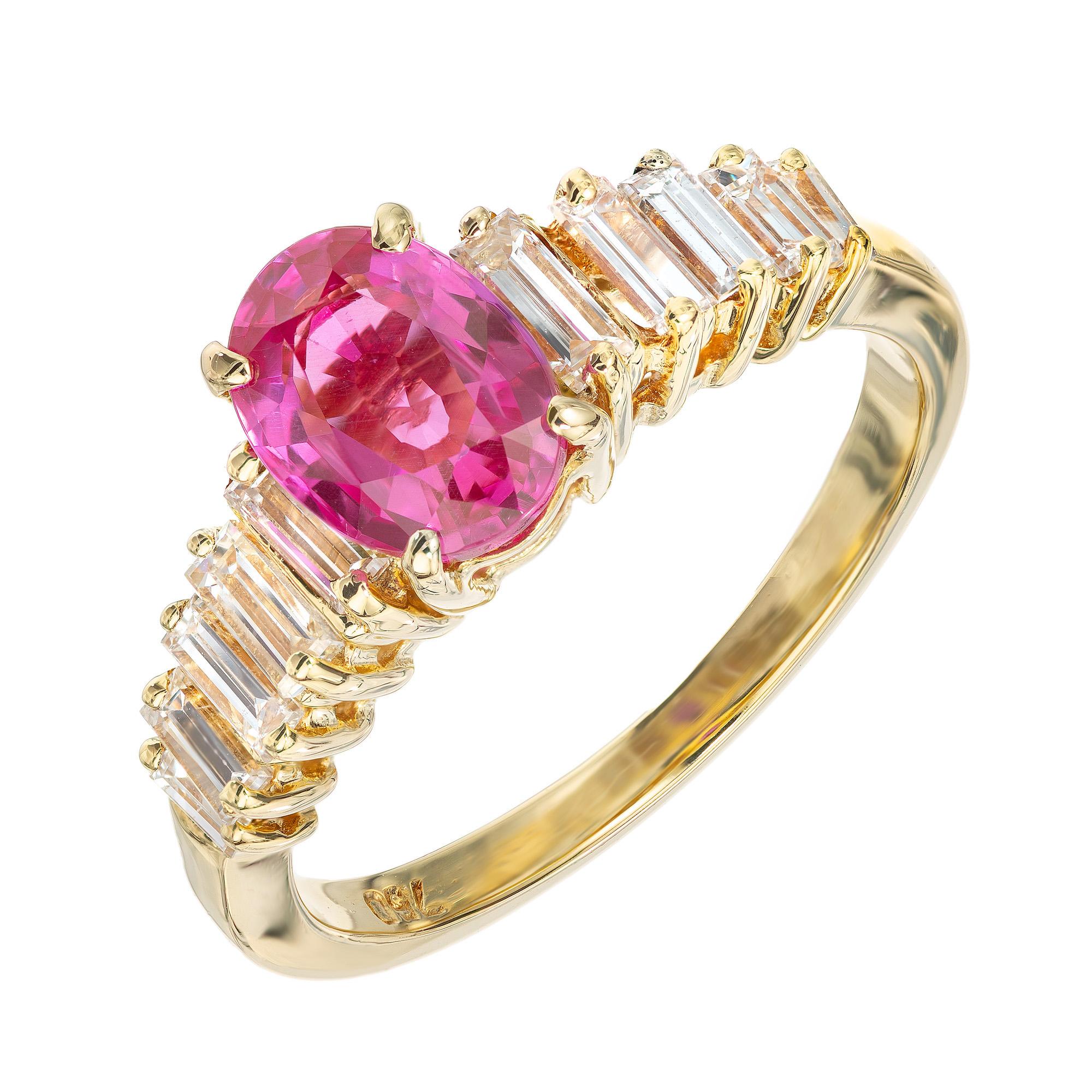 Bright pink sapphire and diamond engagement ring. Mounted in this 18k yellow gold setting is a rich vibrant pink oval 1.20ct sapphire, which is accented by 10 graduated straight baguette diamonds. The sapphire is certified by the AGL as natural, no