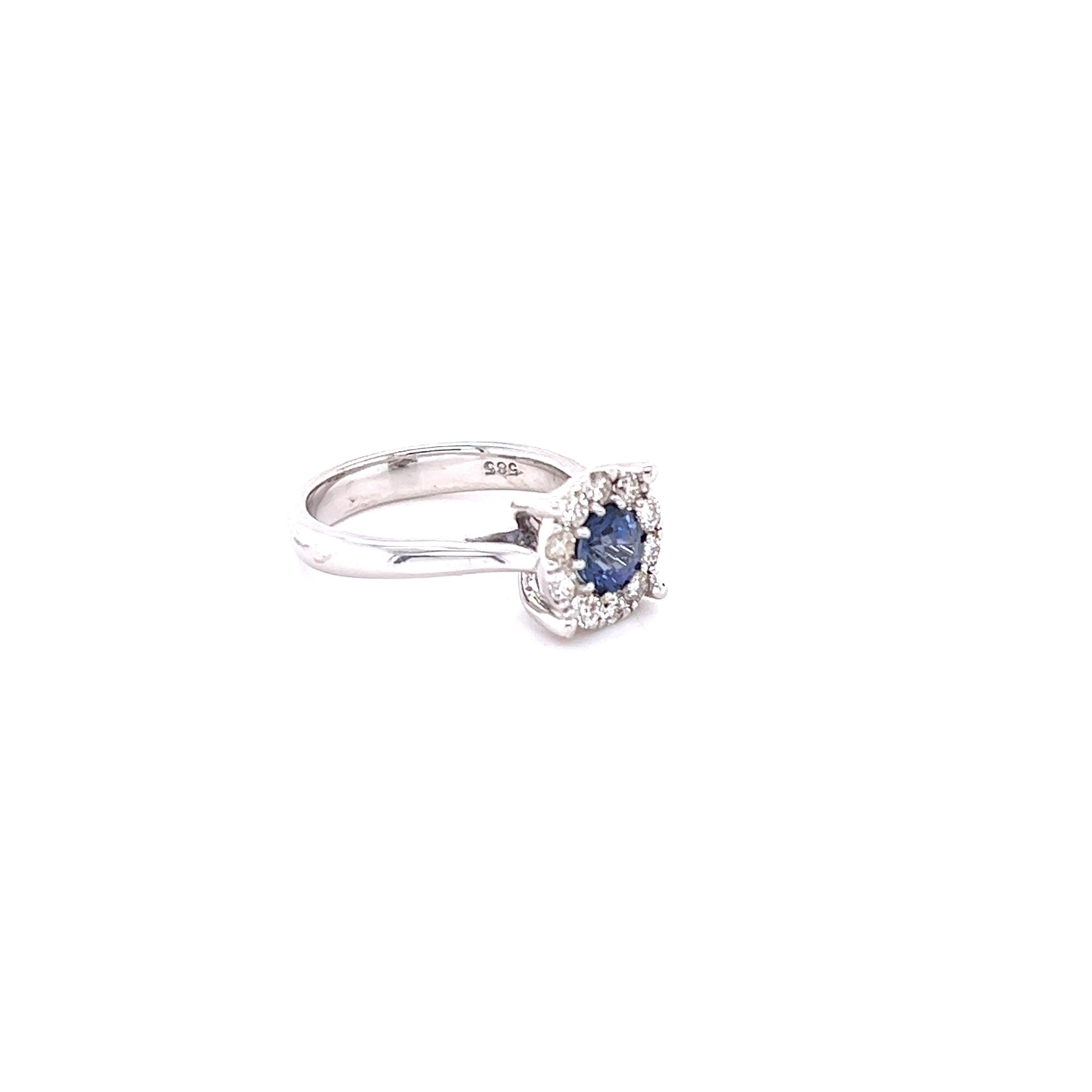 This beauty has a Round Cut Blue Sapphire that weighs 0.82 Carats and measures at 5 mm. It also has 10 Round Cut Diamonds that weigh 0.38 Carats. Clarity: VS, Color: H. The total carat weight of the ring is 1.20 Carats. 

It is set in 14 Karat White