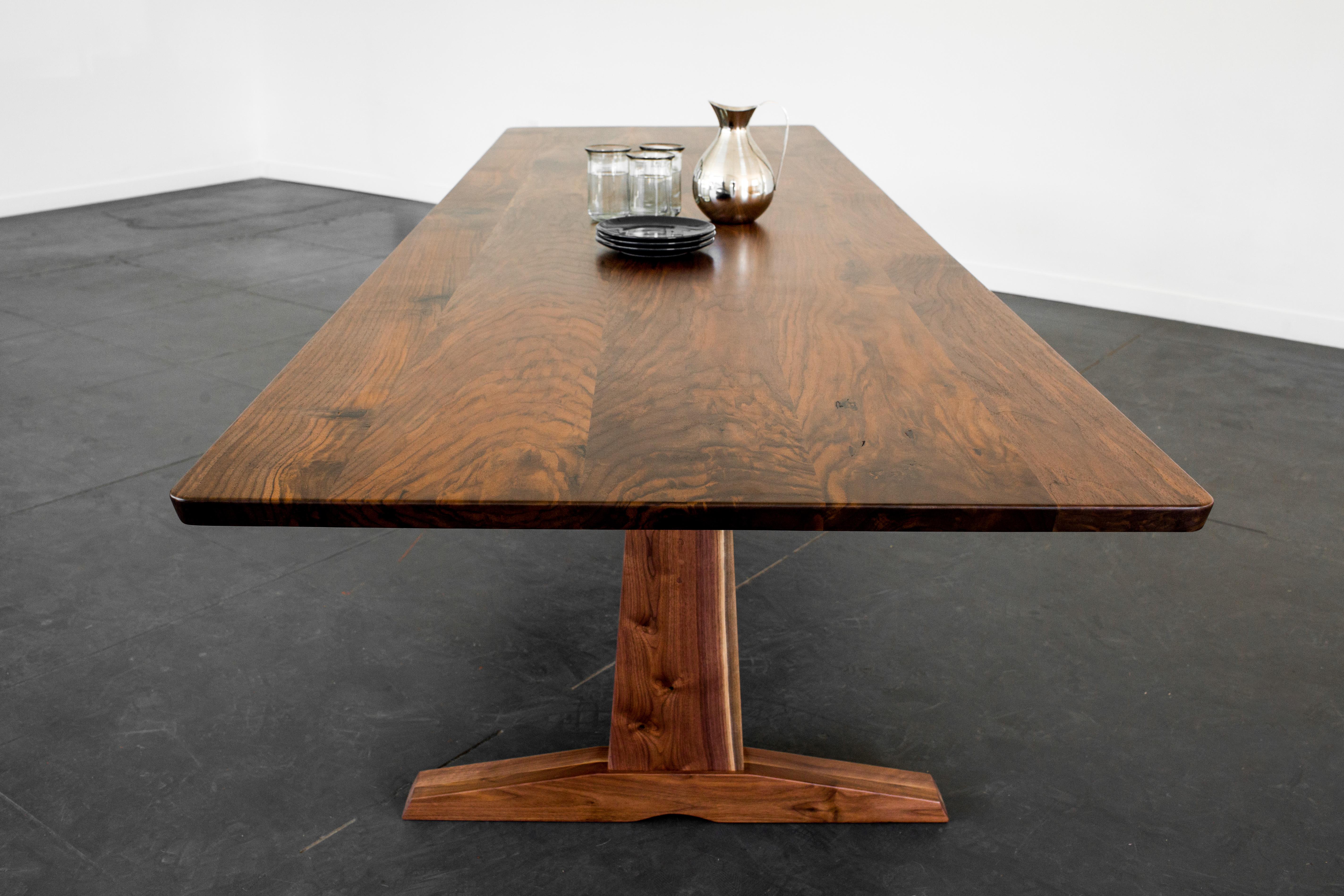 Purpose and design align in our Columbia trestle table. A solid trestle base is the grounding feature in this beautifully crafted modern take on a traditional form. Sleek with a strong profile, this table will be a stately presence in your dining or