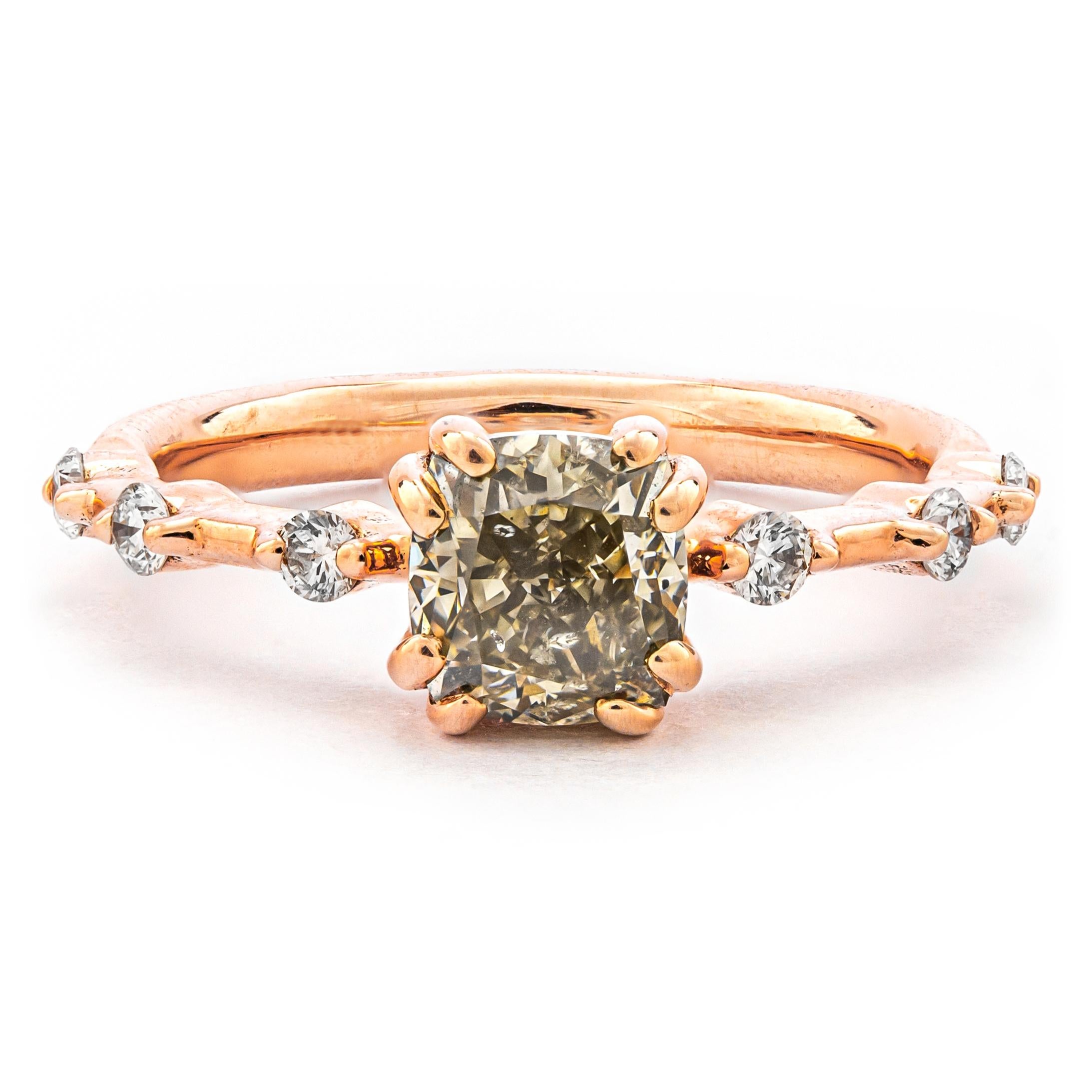 Gorgeous ring has a 1.20 ct Natural Fancy Gray Greenish Yellow Cushion Brilliant Diamond set at the center of a 14k Rose Gold frame accented by 6 colorless white round brilliant diamonds to both sides of the band.