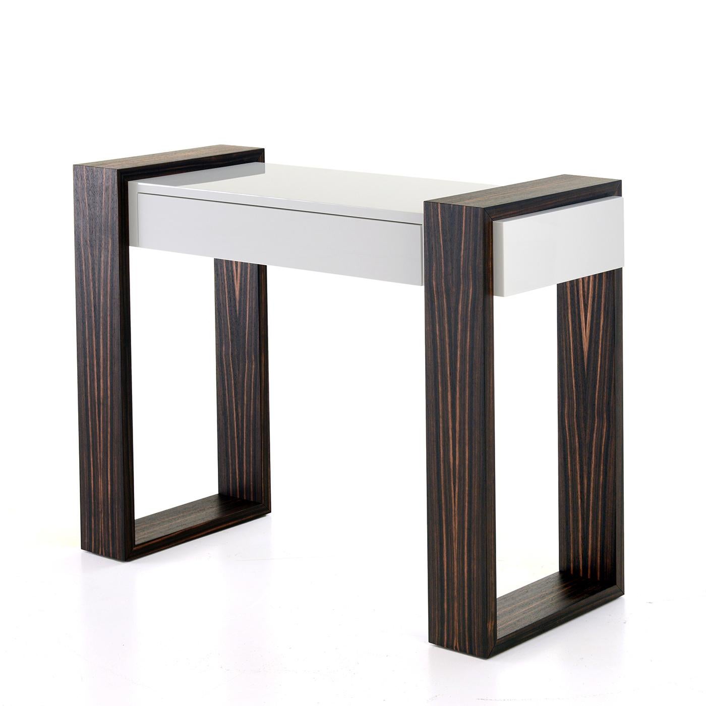 This console represents the whiteness of snow in contrast with the color of ebony wood, one of Africa's most luxurious raw materials, which, when combined together, celebrates the triumph of diversity. This sleek, elegant item also blends modern