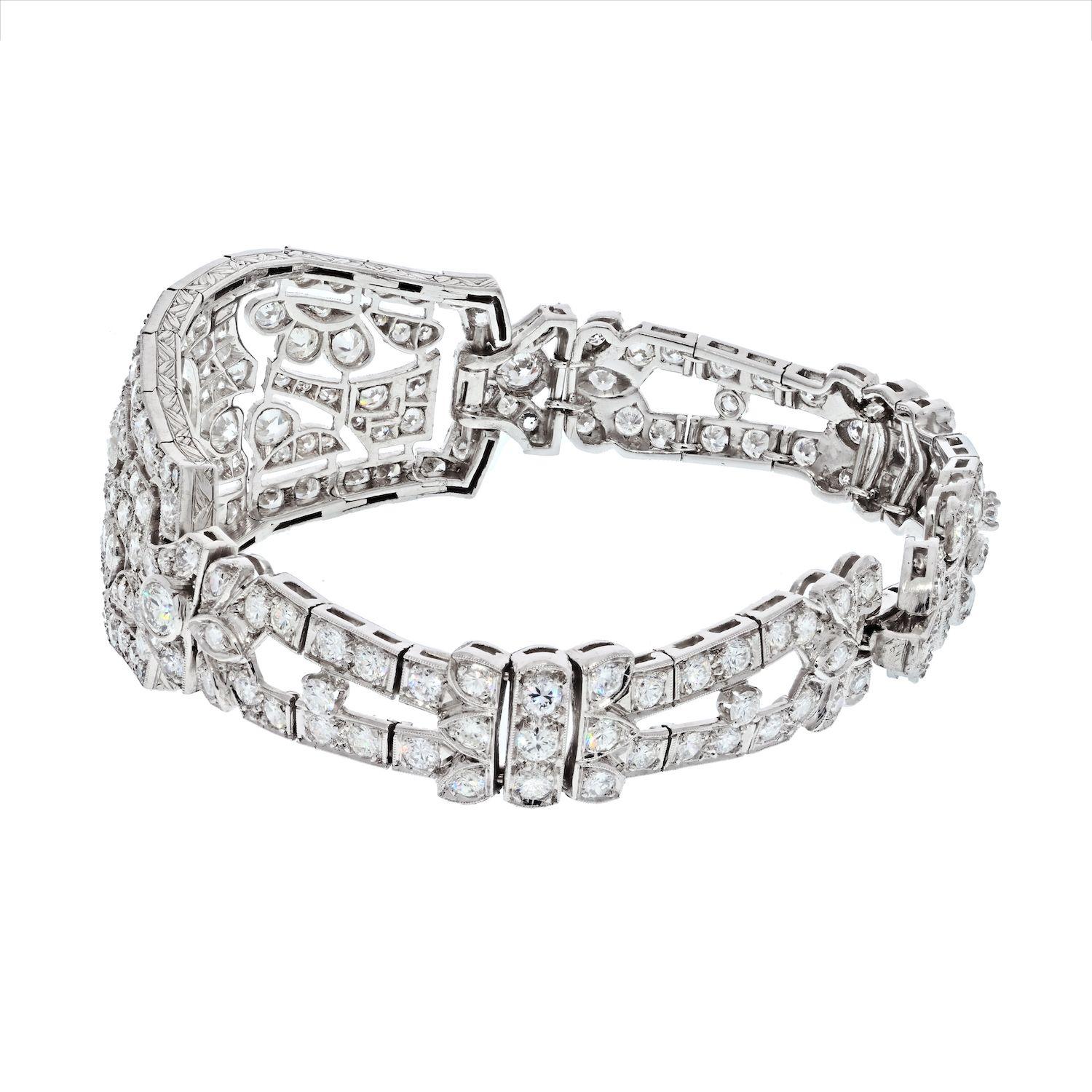 This gorgeous Art Deco bracelet features 12.00 carats of glittering diamonds and a beautiful filigree design in Platinum. The center diamond is a .75 carat old cut gem. The diamond is set in a suspended bezel mounting. A collection of old mine cut