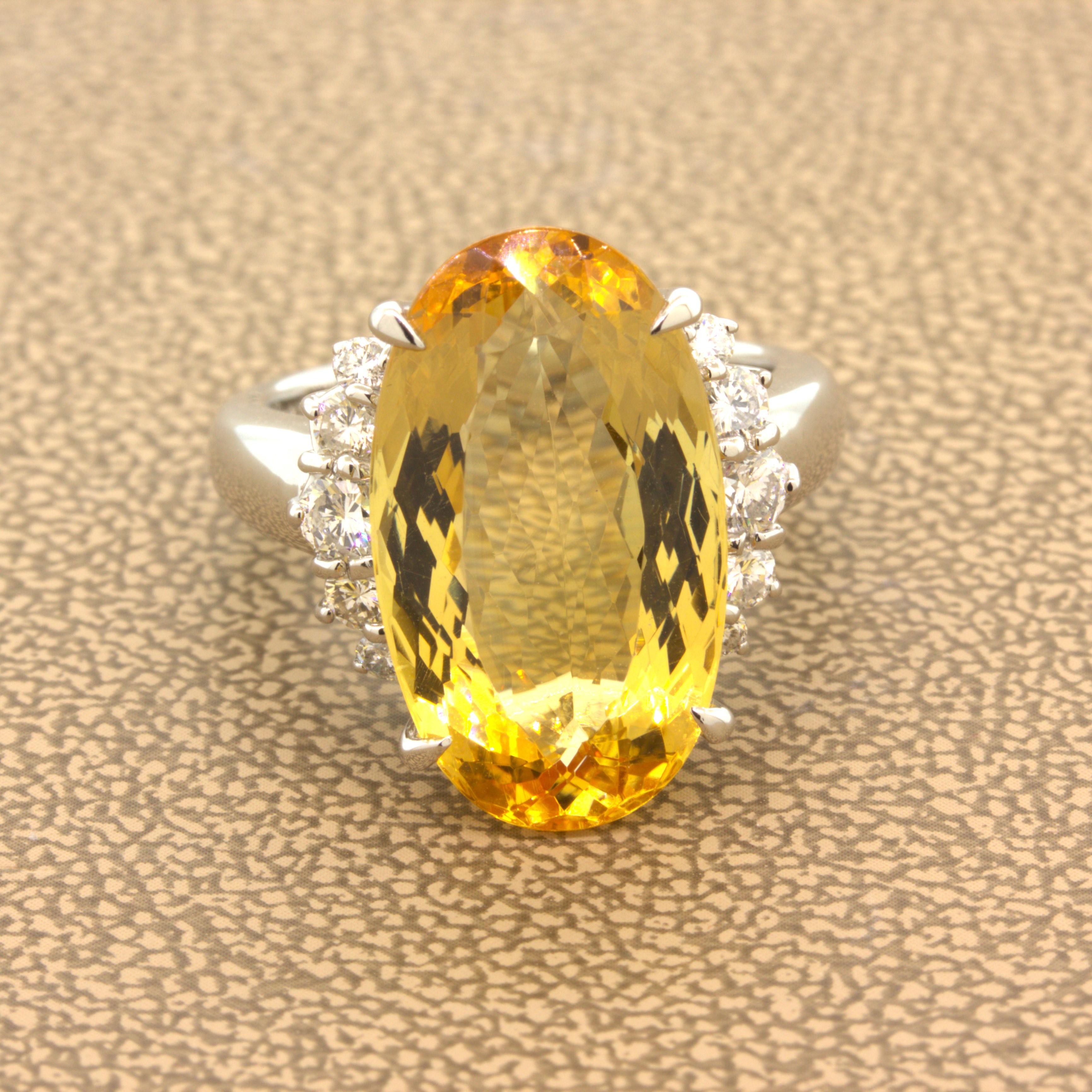 A sleek and elegant ring featuring a fine 12 carat imperial topaz! It has a lovely long oval shape along with a rich and vibrant golden orange-yellow color with excellent brilliance and light return. It is complemented by 10 round brilliant-cut