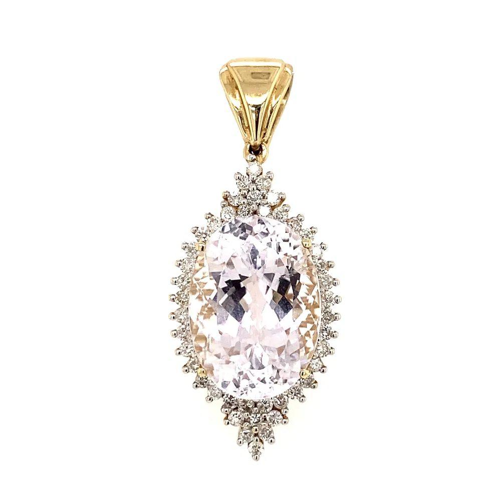 Simply Beautiful! Kunzite and Diamond Gold Pendant. Featuring an Awesome Oval Kunzite, weighing approx. 12 Carats. Securely Hand set and surrounded by Diamonds, approx. 0.45tcw. Finely detailed Hand crafted 14K Yellow Gold mounting. Measuring