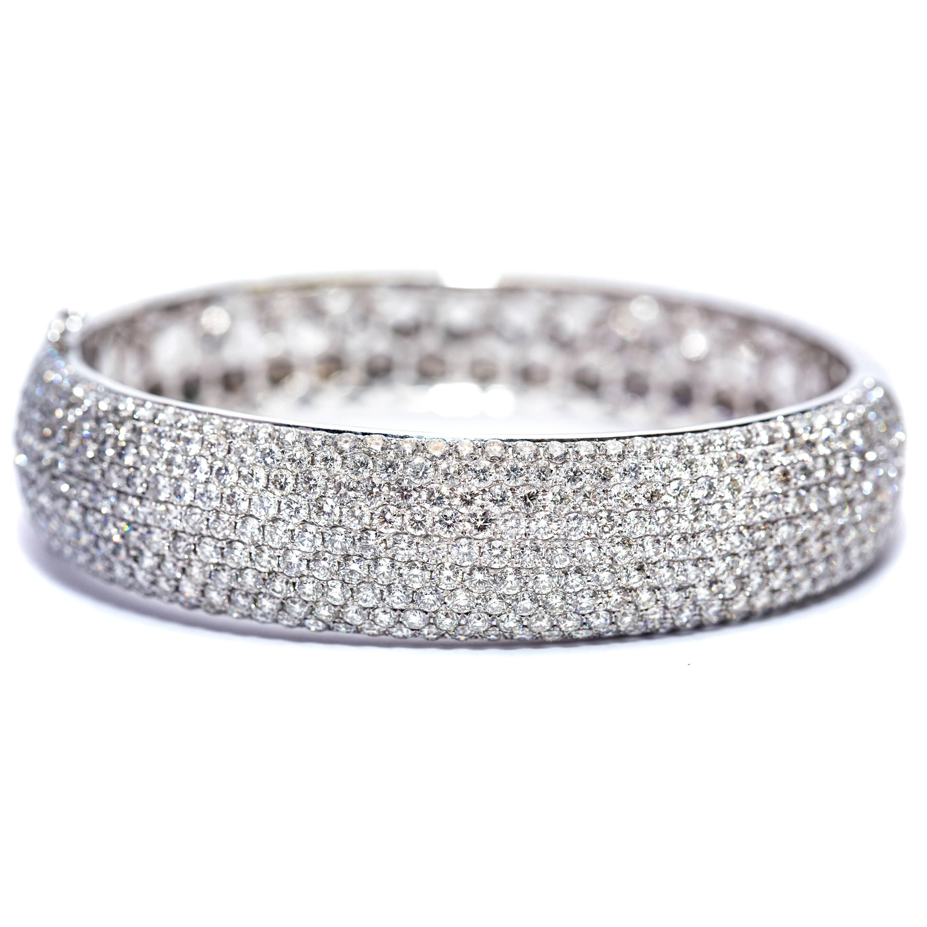 This stunning 12.00 Carat Round Diamond Pave Set Bangle featuring Color G/H Clarity SI1 Round White Diamonds in a pave setting covering half of this beautiful piece, hand crafted honeycomb filigree design on the inside of the bangle and highly