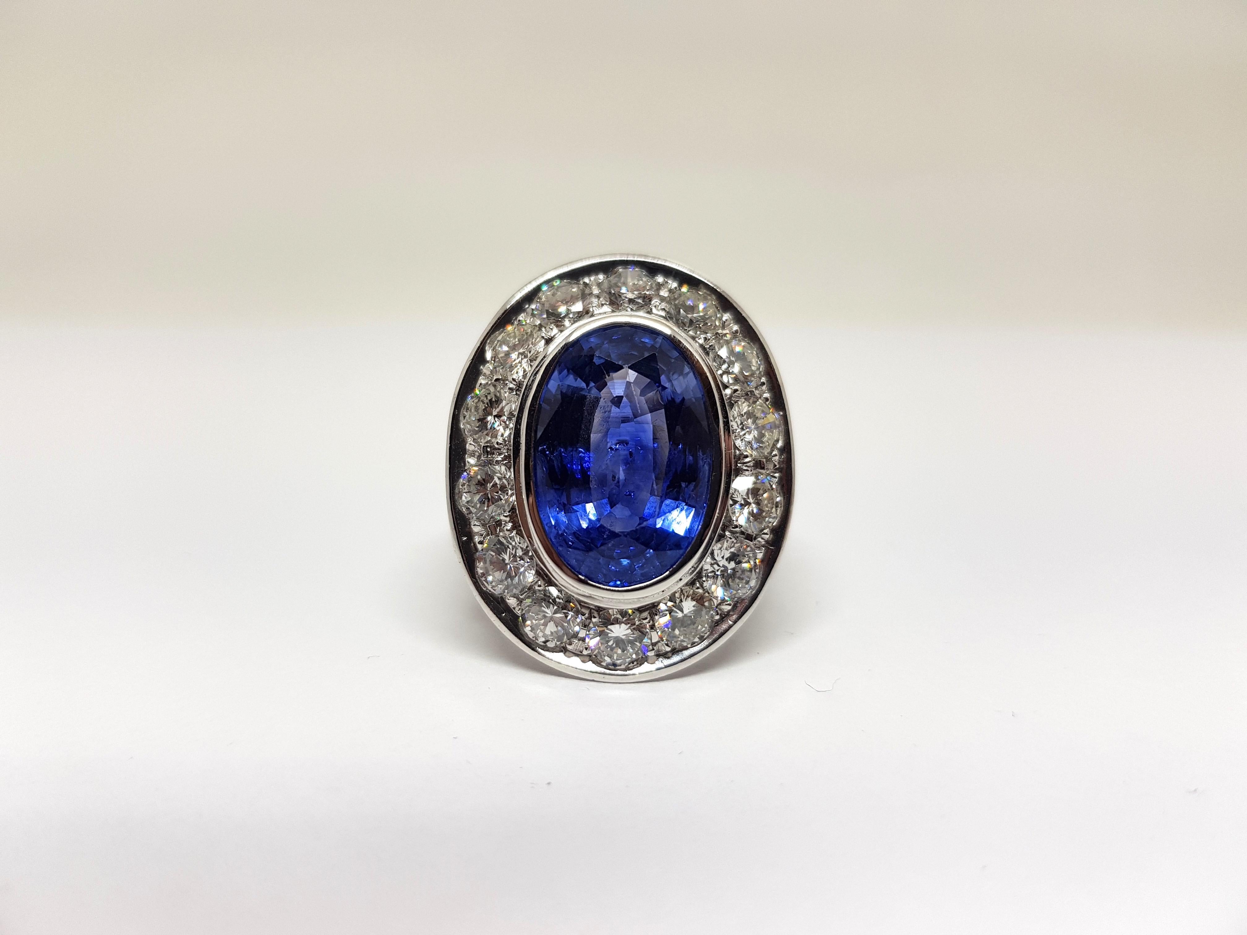 Gold: 18 carat white gold 
Weight: 27,52gr. 
Diamonds: approx. 8,00ct. colour: F-G-H clarity: VS ( 30 Diamonds of 0,25ct. to 0,30ct. each ) 
Sapphire: Oval Mixed Cut approx. 12,00ct. Blue Transparent Enhanced
Width: 0,36 Inches
Ring size: free