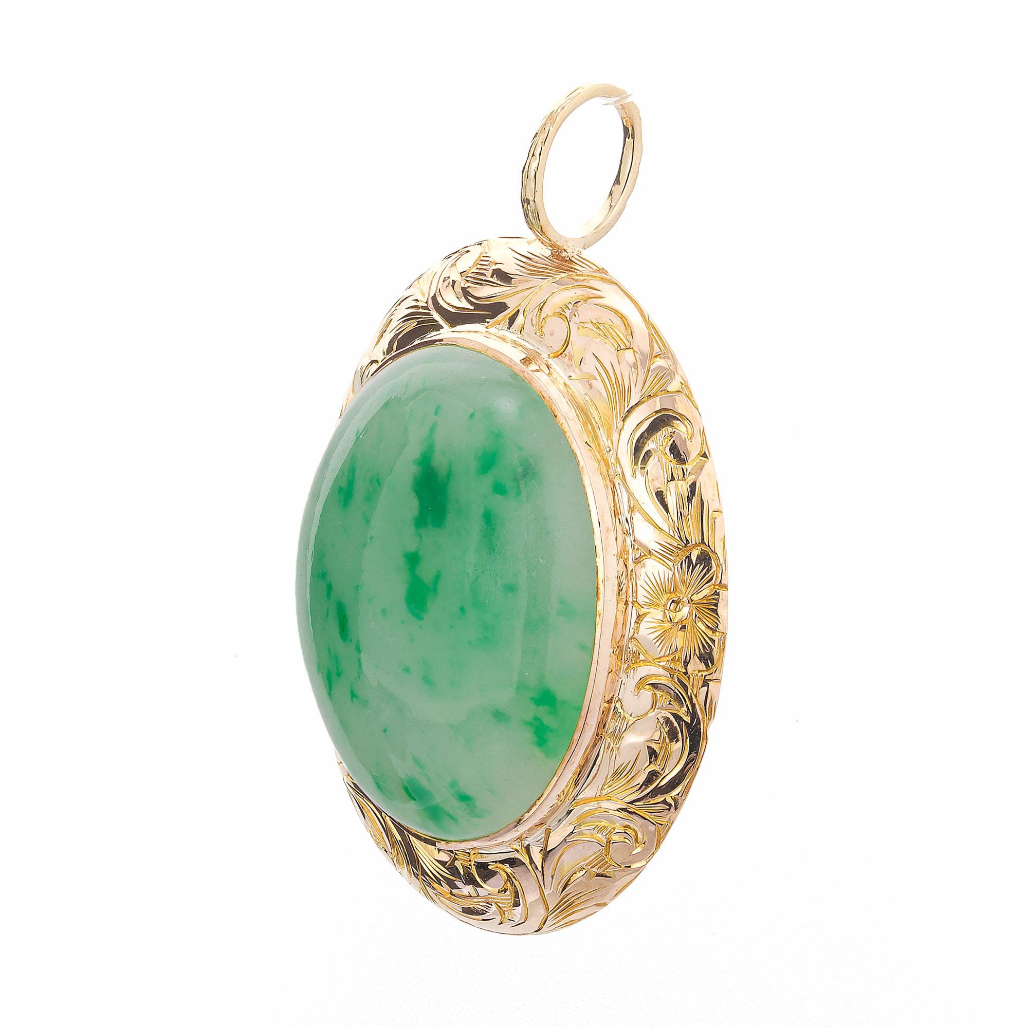 Handmade hand engraved 14k rose gold pendant set with natural untreated GIA certified green and white Jadeite Jade. Circa 1930.

1 oval translucent green and white genuine natural Jadeite Jade, approx. total weight 12.00cts, 19.6 x 15.65 x 5.6mm,