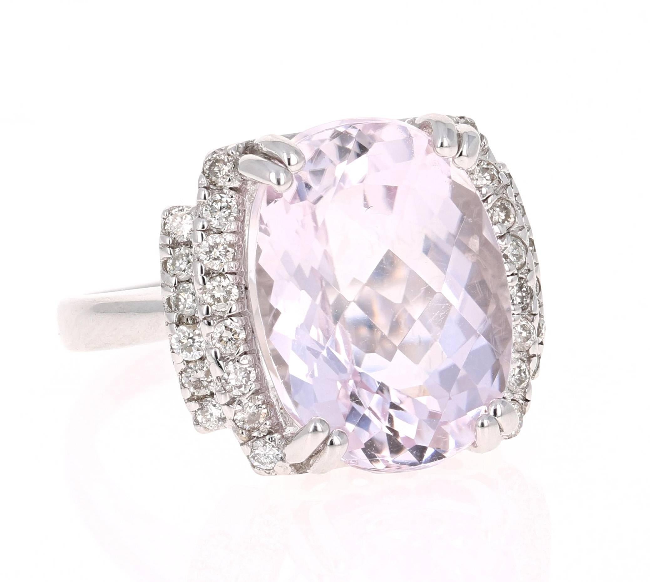 This stunning piece has a large 11.57 carat Kunzite that is set in the center of the ring, it is surrounded by 28 Round Cut Diamonds that weigh 0.44 carats.  The total carat weight of the ring is 12.01 carats. 

The ring is curated in 14K White gold