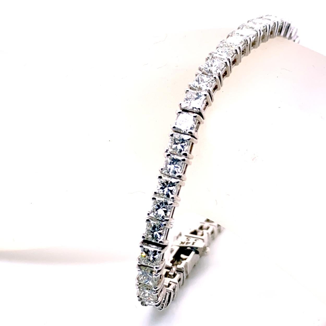 This Diamond Tennis Bracelet consists of 50 Links of 4-Prong Set 3.4mm (1/4 Ct) Princess Cut diamonds set in 14K White Gold.   The bracelet comes with a  Built-In Safety Lock to protect it from loss. 
Total Weight of diamonds: 12.02 Ct 
Total Weight