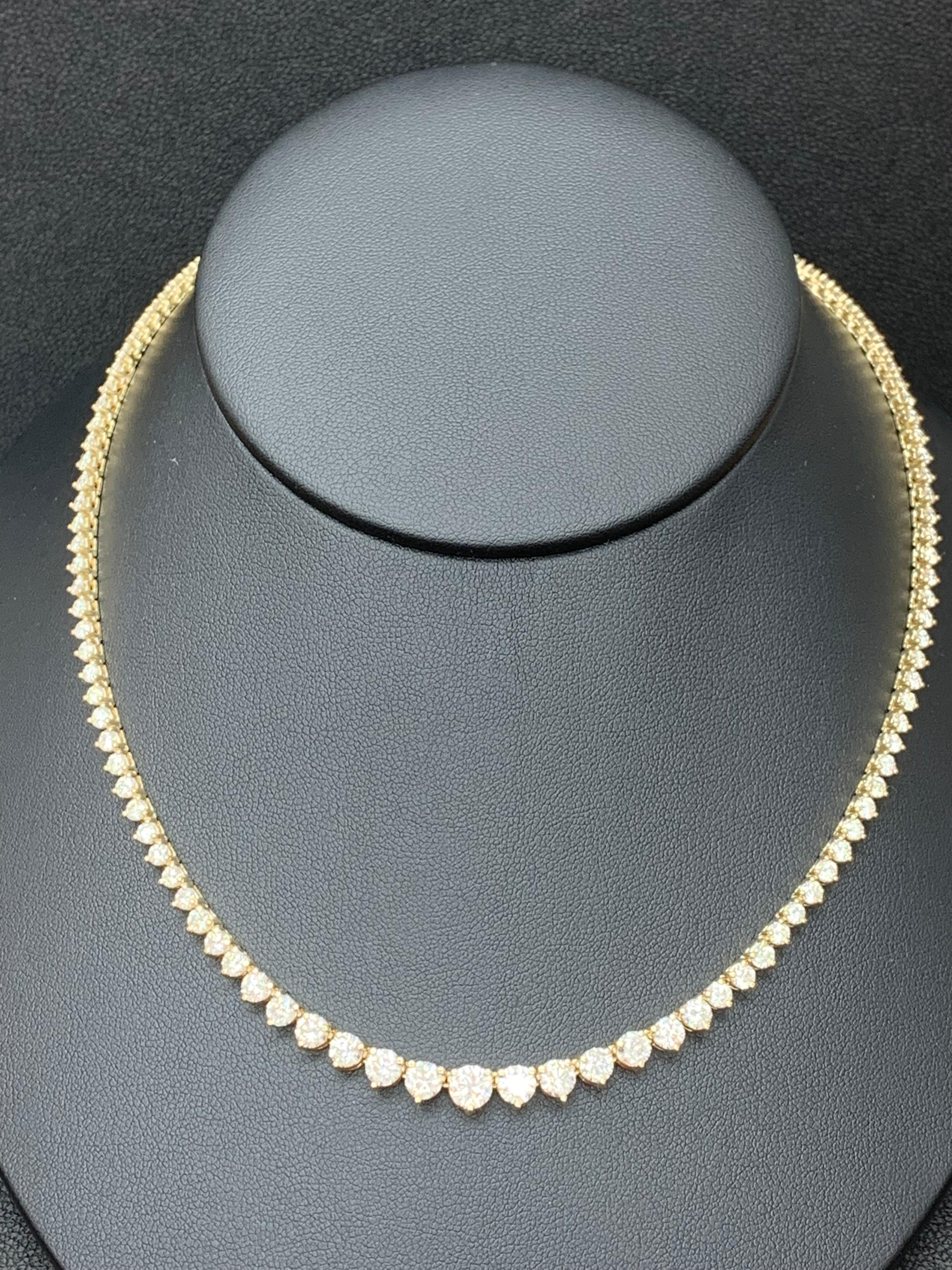 An important and brilliant necklace showcasing graduating round brilliant diamonds weighing 12.05 carats total, each set in a three-prong basket made in 14 karat yellow gold. Has an invisible double lock mechanism for a seamless, brilliant