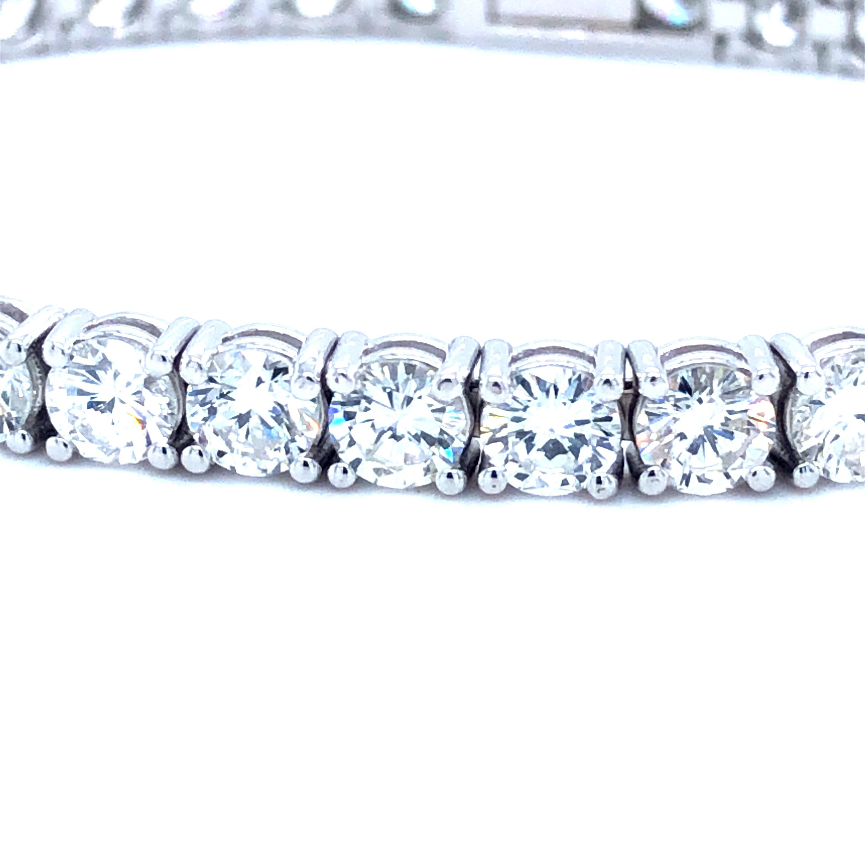 Offered here is a stunning large straight-line tennis bracelet, showcasing 37 natural earth mined excellent quality round diamonds weighing 12.05 carats total, near colorless averaging G-H in color and near flawless averaging VS2-SI1 in clarity.
A