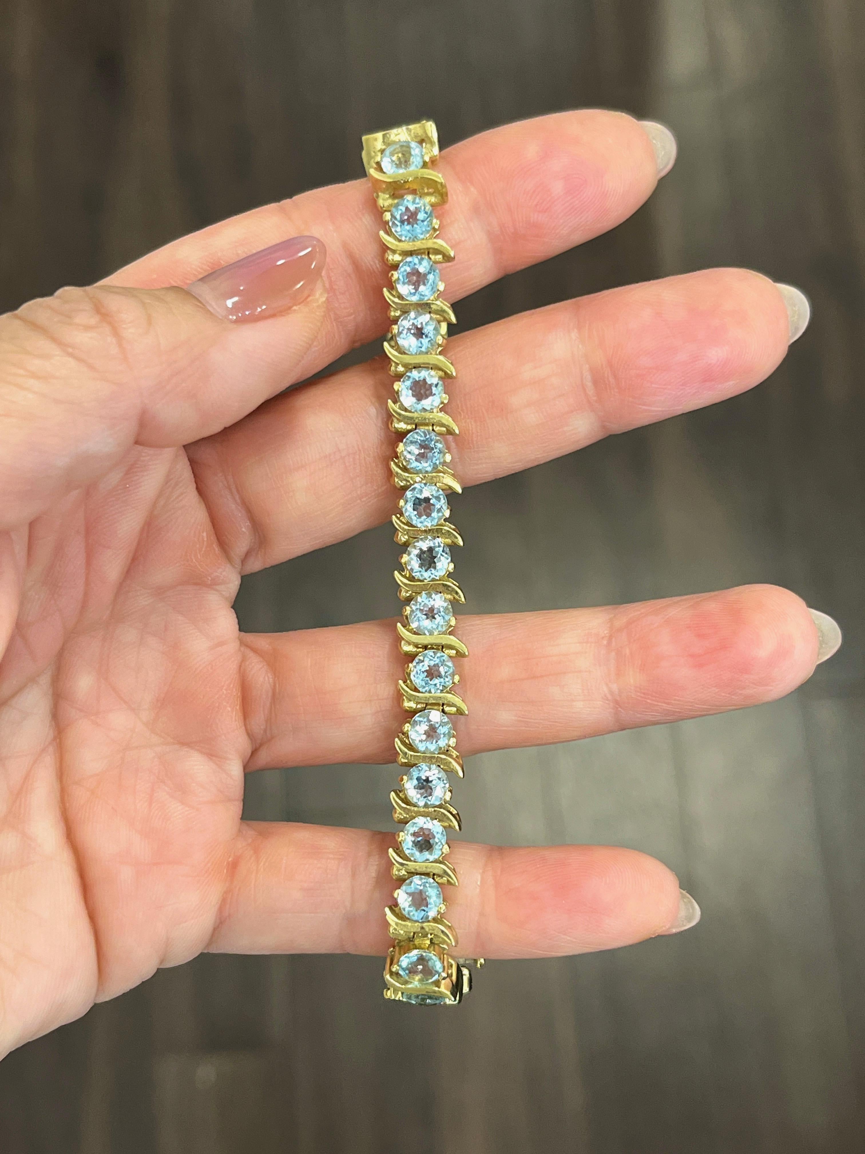 This gorgeous 12.08 ct natural aquamarine bracelet set in 14k yellow gold boasts 28 aquamarine stones. This is a beautiful piece to dress up any wardrobe, or with any everyday outfit.  