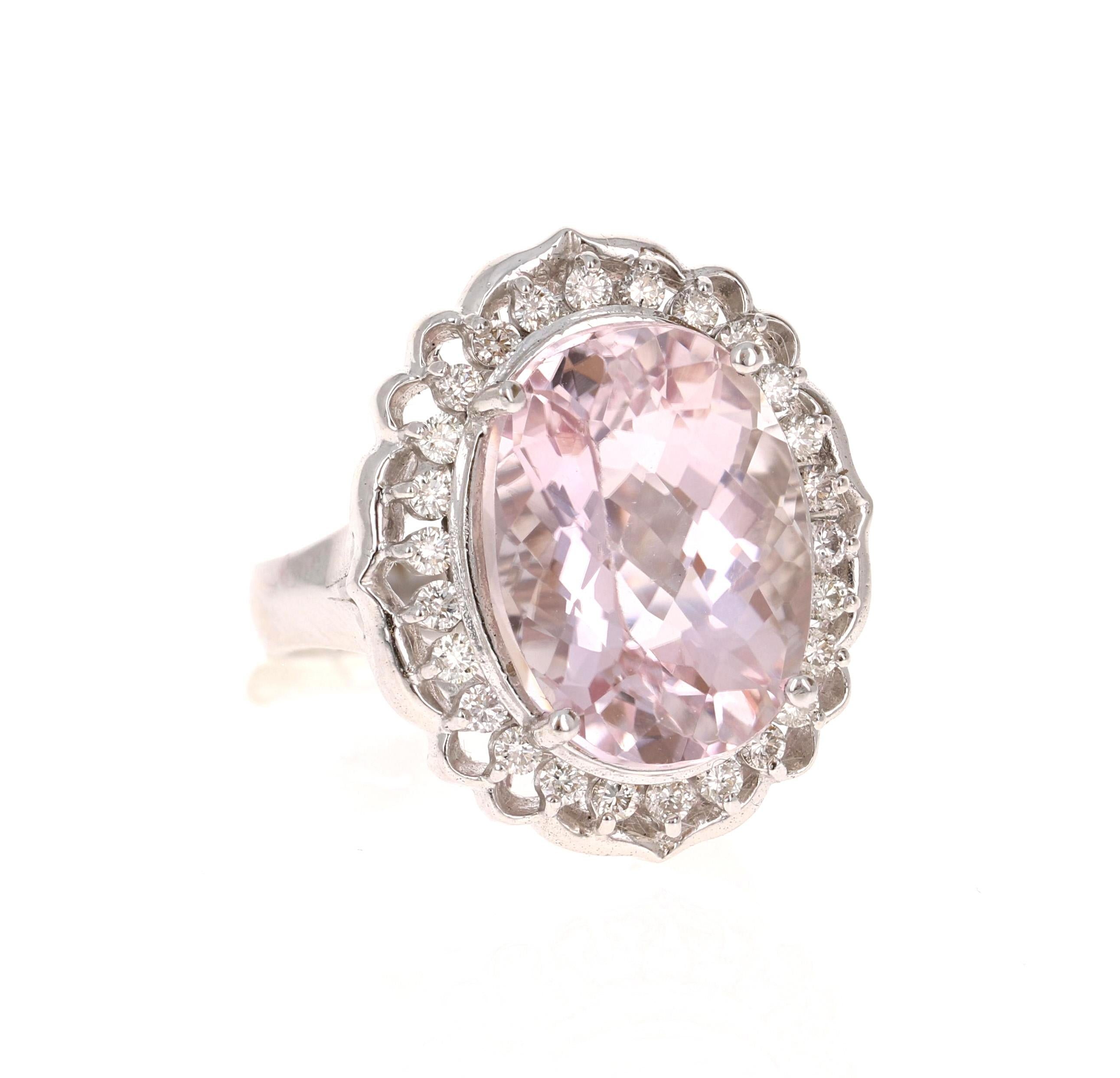 A beautiful Kunzite Ring resembling a fresh dainty flower. This gorgeous Kunzite Diamond Ring has a 11.53 Carat Oval Cut Kunzite as its center and is surrounded by 26 Round Cut Diamonds that weigh 0.56 carats. The total carat weight of the ring is
