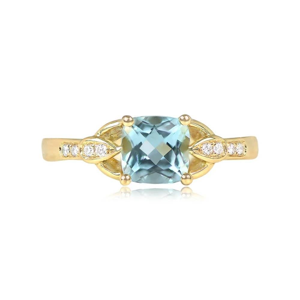 A one-of-a-kind ring showcasing a stunning 1.20-carat cushion-cut aquamarine, pristinely set in prongs, revealing a mesmerizing teal hue. Adorning the shoulders are four round brilliant cut diamonds on each side, enhancing its elegance. Meticulously