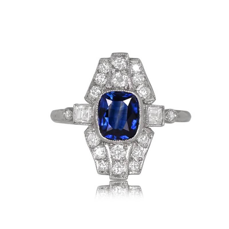 A distinctive ring showcasing an elongated 1.20-carat cushion-cut natural sapphire with captivating blue saturation. The center sapphire is encircled by a dazzling arrangement of diamonds, totaling around 0.60 carats. Crafted in platinum, this