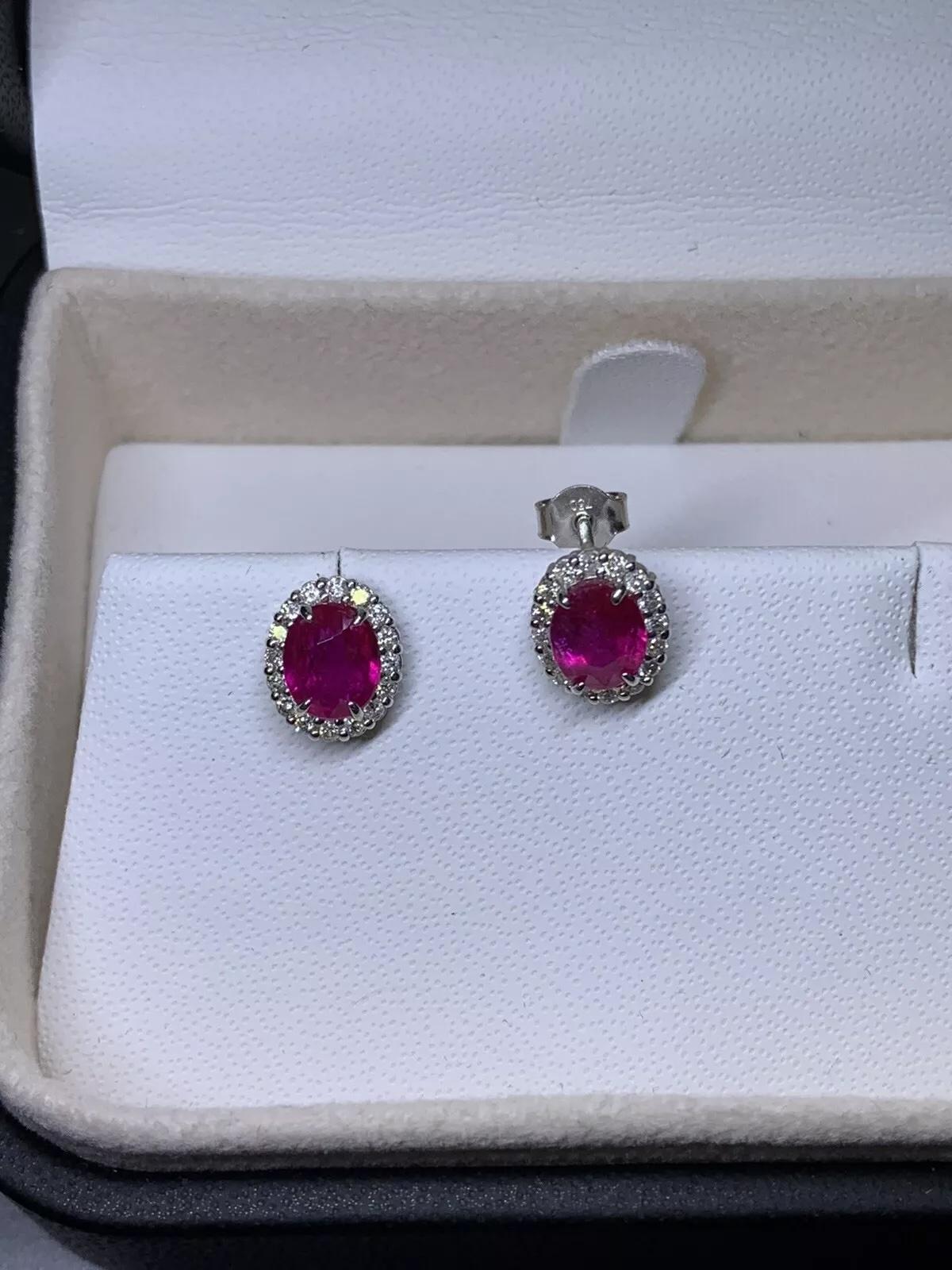 Oval Cut 1.20ct Diamonds and oval ruby halo stud earrings in 18k white gold. For Sale