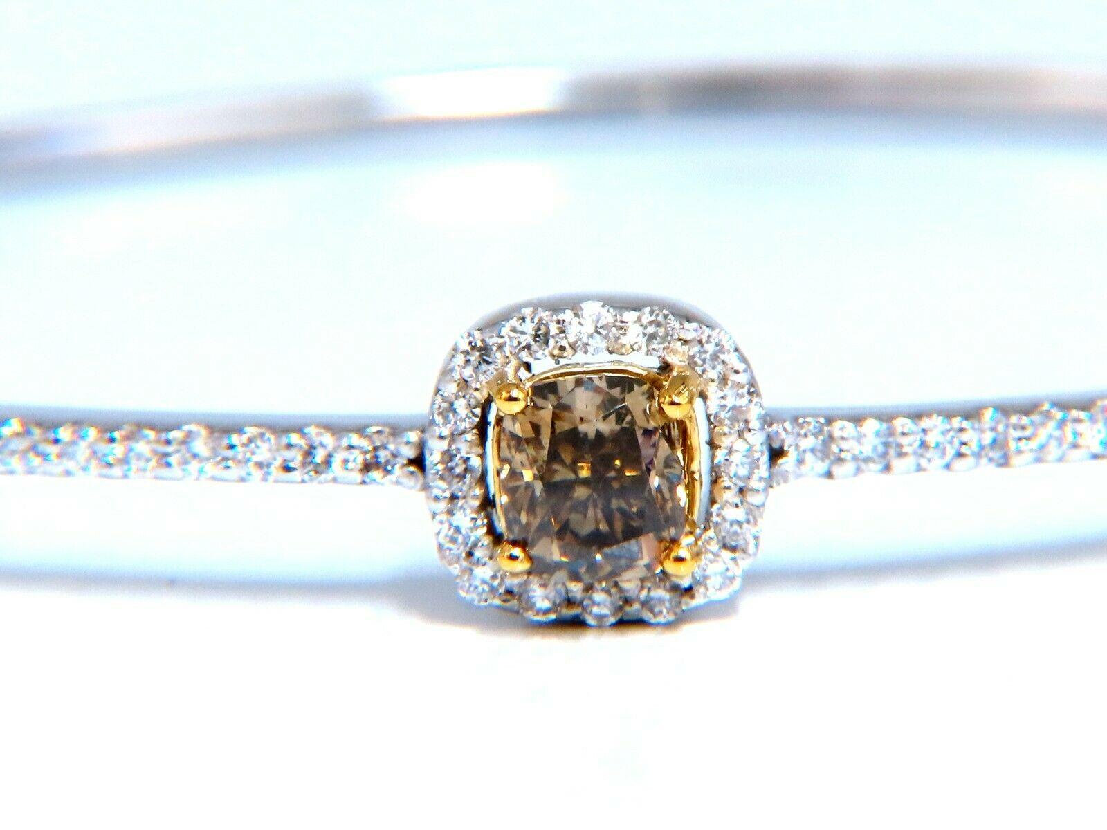 Fancy Diamond Bangle.

.56ct. Natural fancy color bracelet.

Yellow Brown Color

Cushion- Full cut

Vs-2 clarity.

.64ct Natural round diamonds

G-color Vs-2 Clarity

14kt. white gold 

10.1 Grams.

7.7 x 8.1mm top cluster

cluster depth: