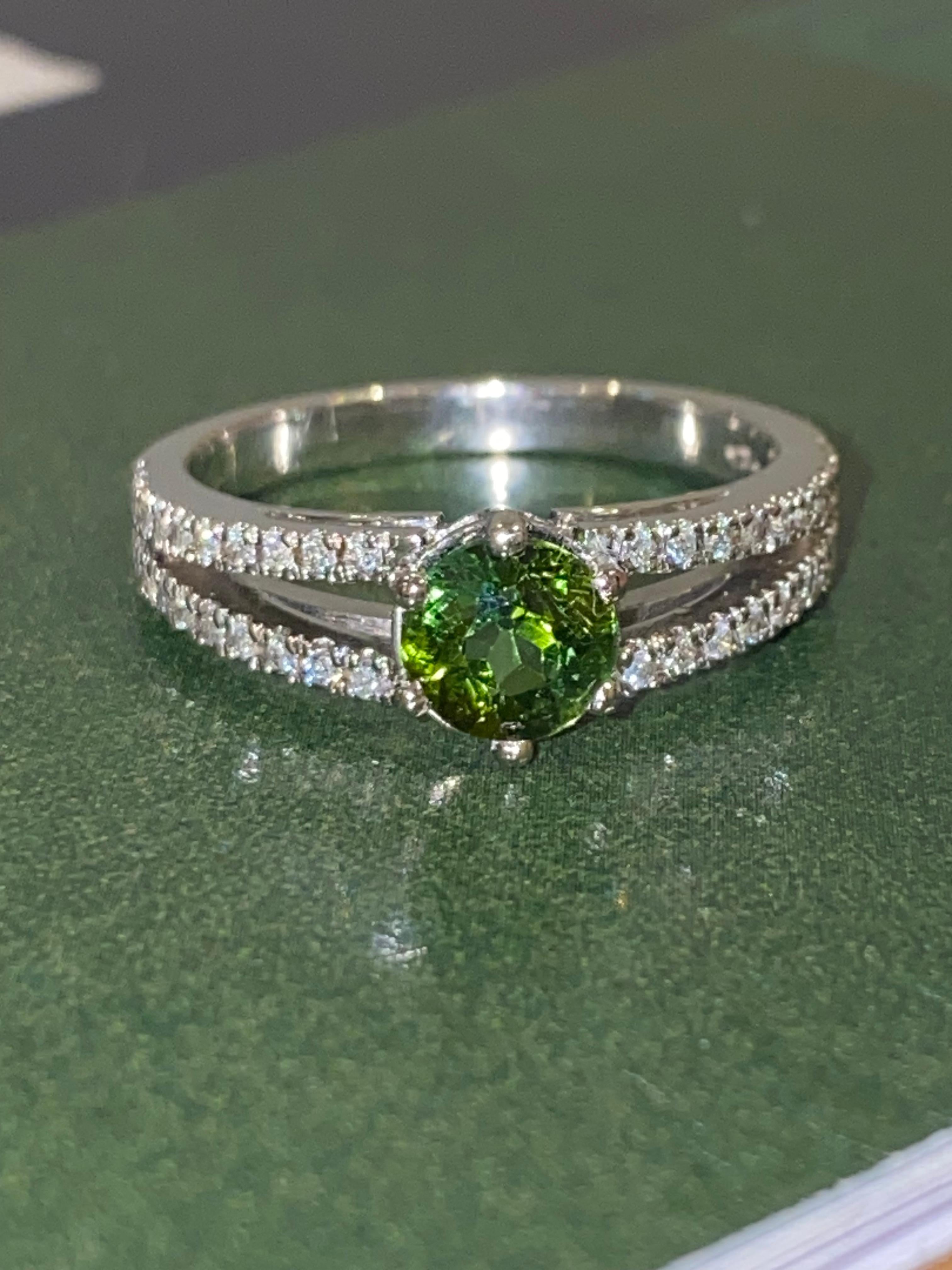 Of eternally popular solitaire with accents design,

this piece is crafted with refined elegance

in 18K White Gold

 

Centring a magnificent Round Natural Verdelite Tourmaline

of 1.20ct,

of intense vivid green colour & excellent clarity



One