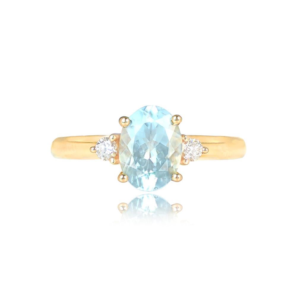 This gemstone engagement ring showcases a 1.20-carat oval-cut aquamarine, elegantly set in prongs and complemented by round brilliant cut diamonds adorning the shoulders. The total diamond weight for this exquisite piece is approximately 0.10