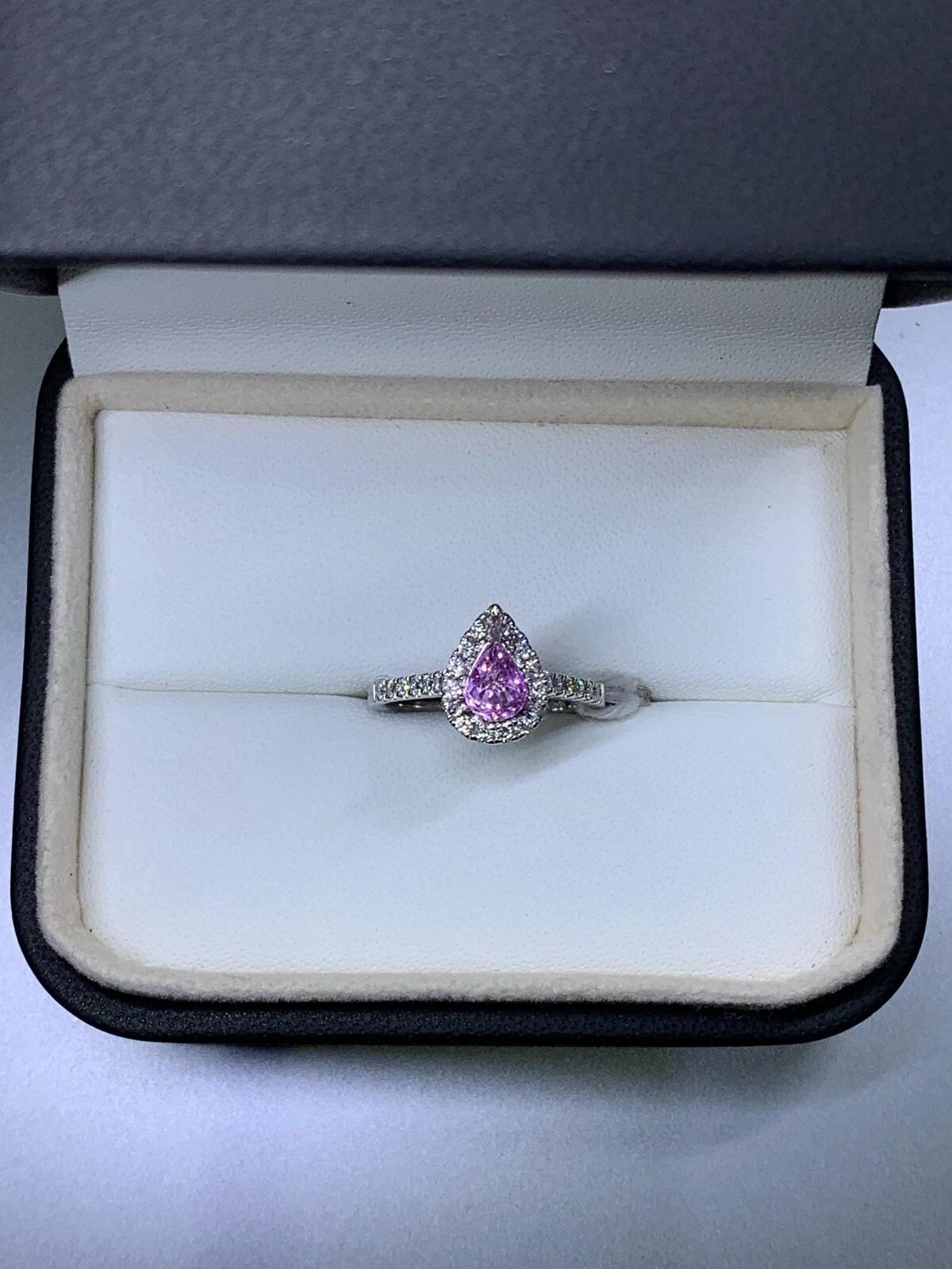 1.20ct Pink sapphire vivid pear diamond halo engagement ring 18k white gold.

Beautiful pink vivid sapphire pear shape natural untreated total weight 0.85ct with diamond halo total weight 0.35ct in 18k white gold band.

Pink intense sapphire