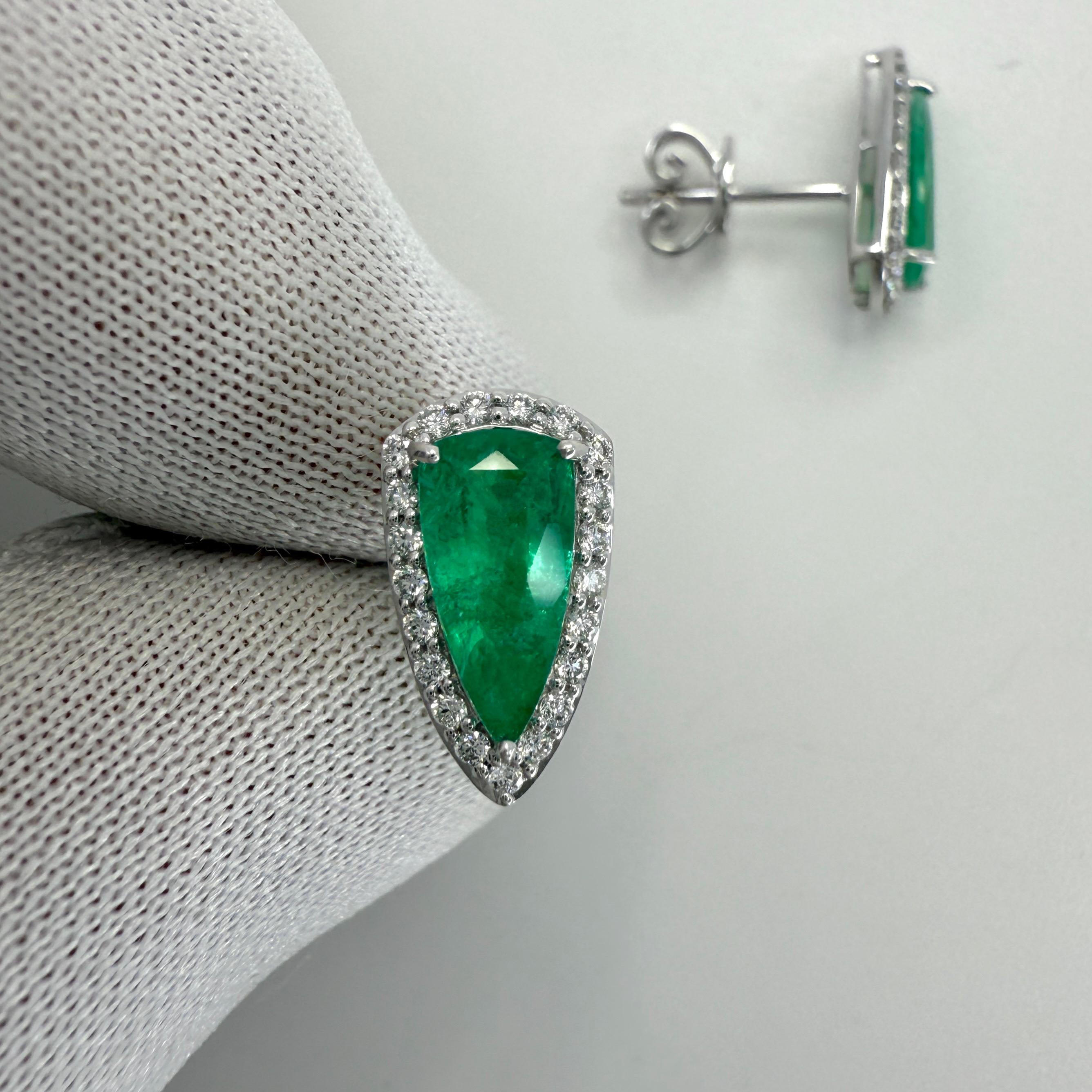 Natural Vivid Green Teardrop Cut Emerald And Diamond 18k White Gold Halo Earring Studs. 1.43 Carat total.

These earrings feature two fine natural emeralds with a vivid green colour and an excellent teardrop cut measuring 9.5x4.5mm. Approx. 1.20