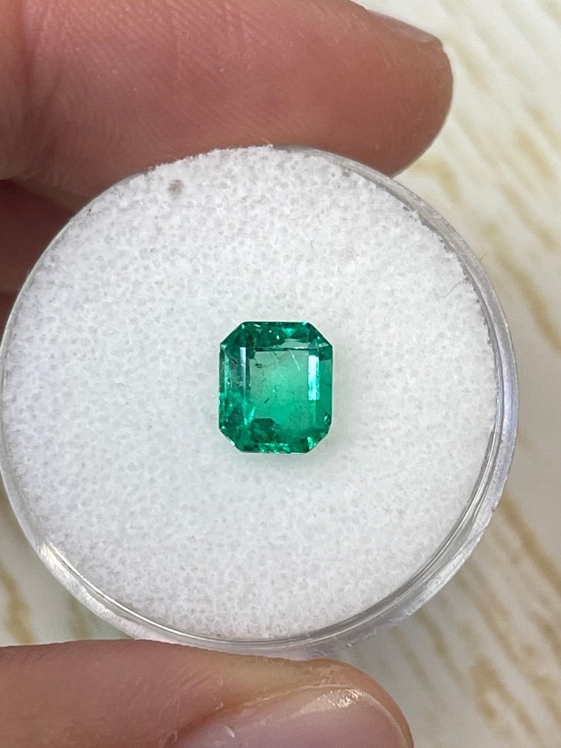 Stone: Emerald
Weight: 1.20-carats
Shape: Emerald Cut
Clarity: Transparent
Luster: Excellent
Color: Yellowish Green
Measurements: 7.25mm x 6.22mm x 4.08mm
Geographic Origin: Colombia
Treatment: Natural, Oiling

Comments: Due to their growth