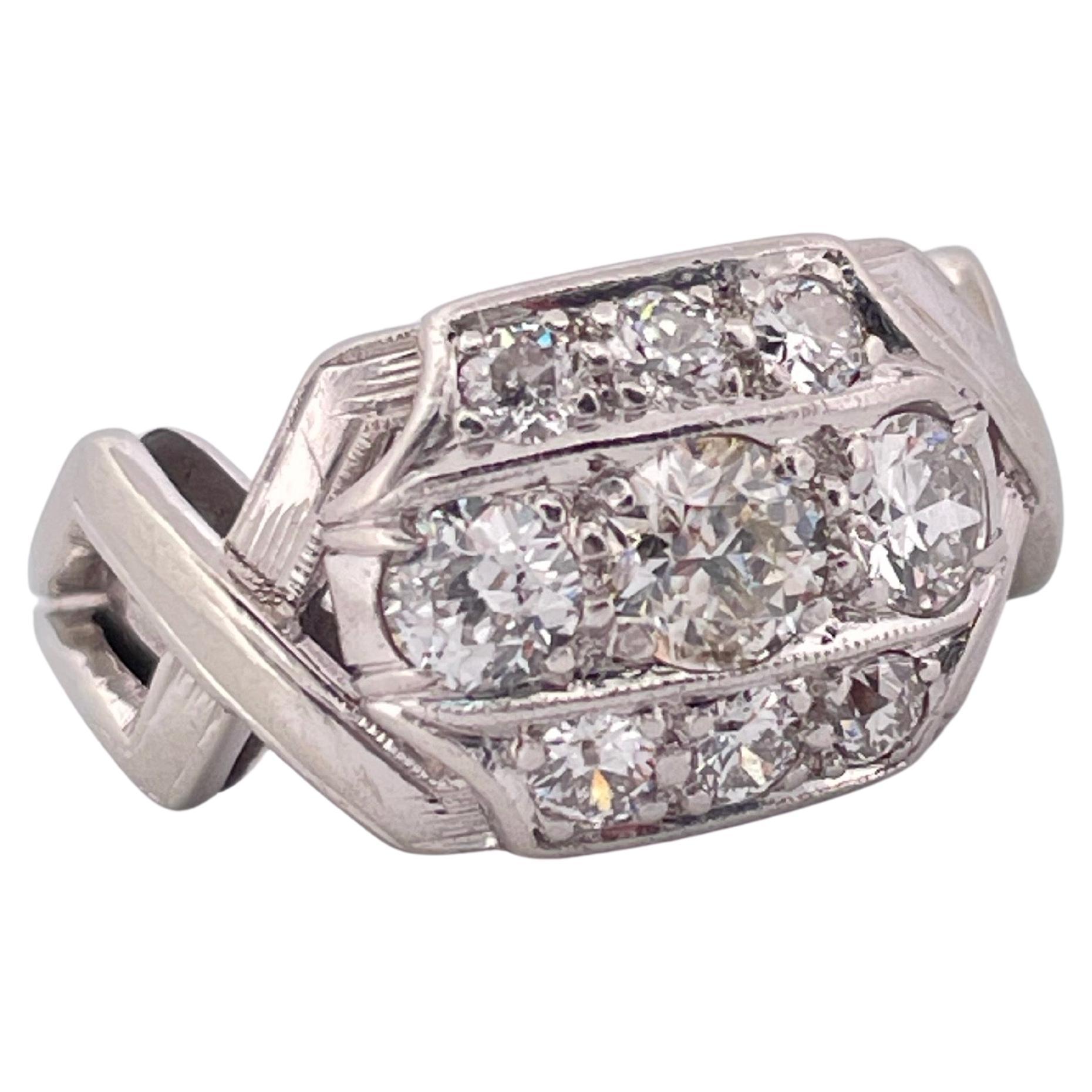 Dieser elegante Diamantring im Vintage-Stil ist aus massivem 14-karätigem Weißgold gefertigt und zeichnet sich durch ein kühnes, strukturiertes Design aus, das für den Stil der Mitte des 20. In der Mitte befindet sich eine Gruppe von Diamanten im
