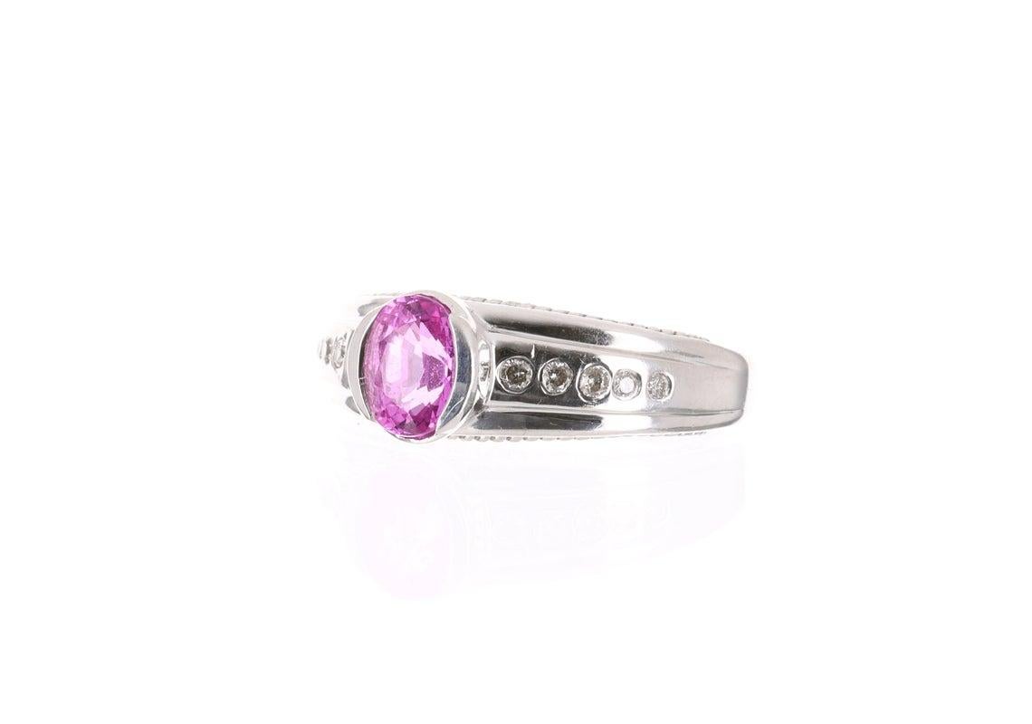Displayed is a gorgeous minimalist/contemporary pink tourmaline and diamond ring. This is quite an alluring piece with a stunning center stone! The center gem is a AAA+ quality pink tourmaline that is hand bezel set. The gemstone has a gorgeous fine