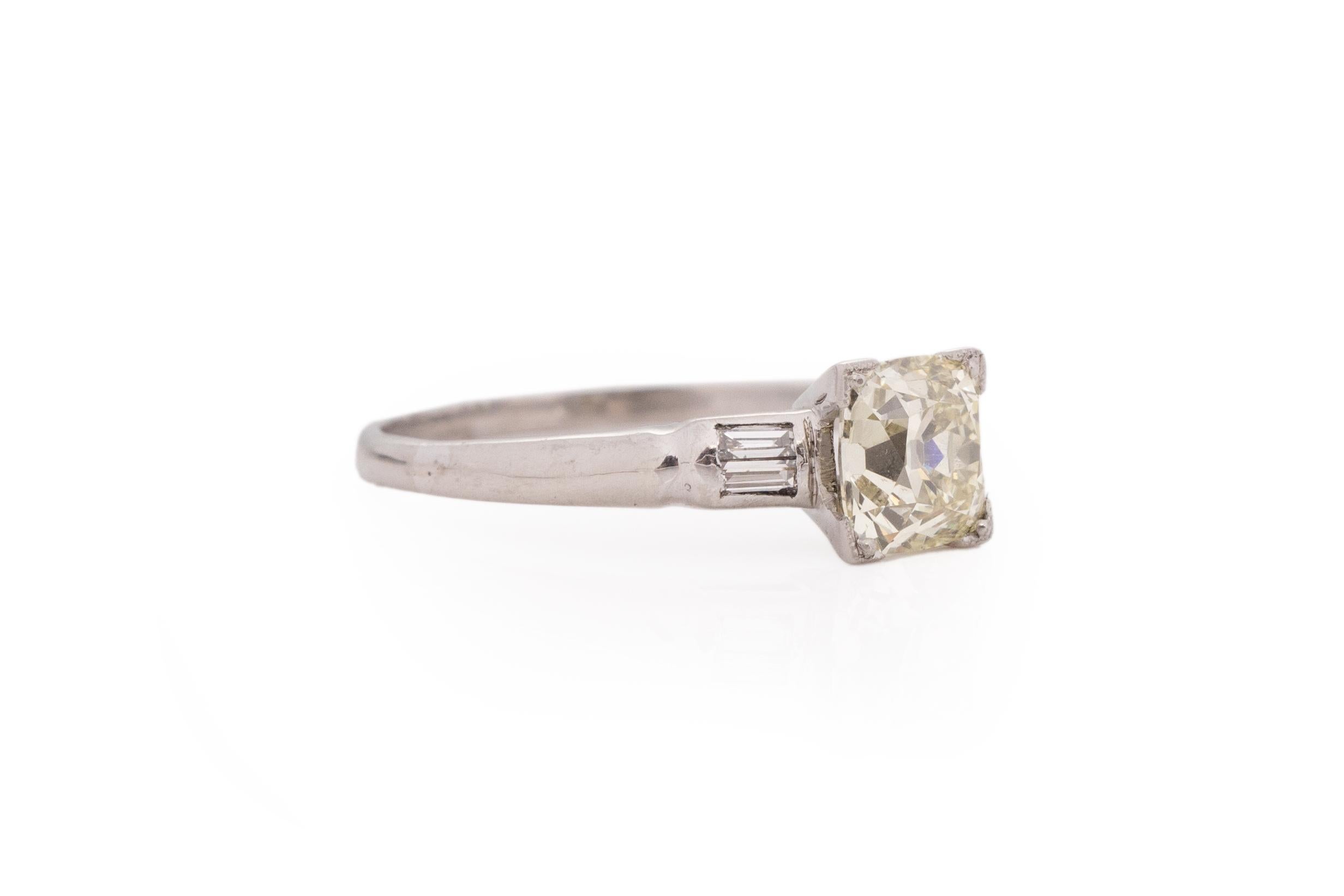 Ring Size: 7
Metal Type: Platinum [Hallmarked, and Tested]
Weight: 2.7 grams

Center Diamond Details:
Weight: 1.21carat
Cut: Antique Cushion
Color: Light Yellow, O/P
Clarity: VS2

Side Stone Details:
Weight: .15carat total weight
Cut: Antique