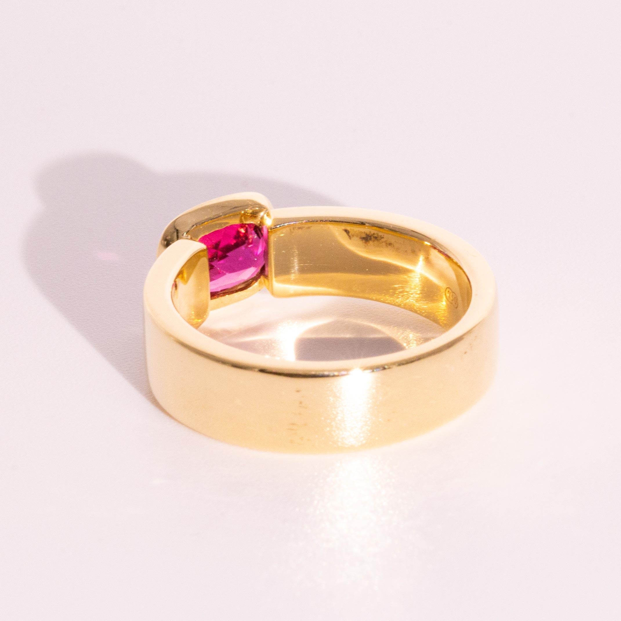 This contemporary 1.21 Carat Cushion Cut Pink Tourmaline 18 Carat Yellow Gold Cocktail Ring features an east west bezel set tourmaline of beautiful colour. A unisex design with a timeless appeal, this ring really makes the most of the gemstone