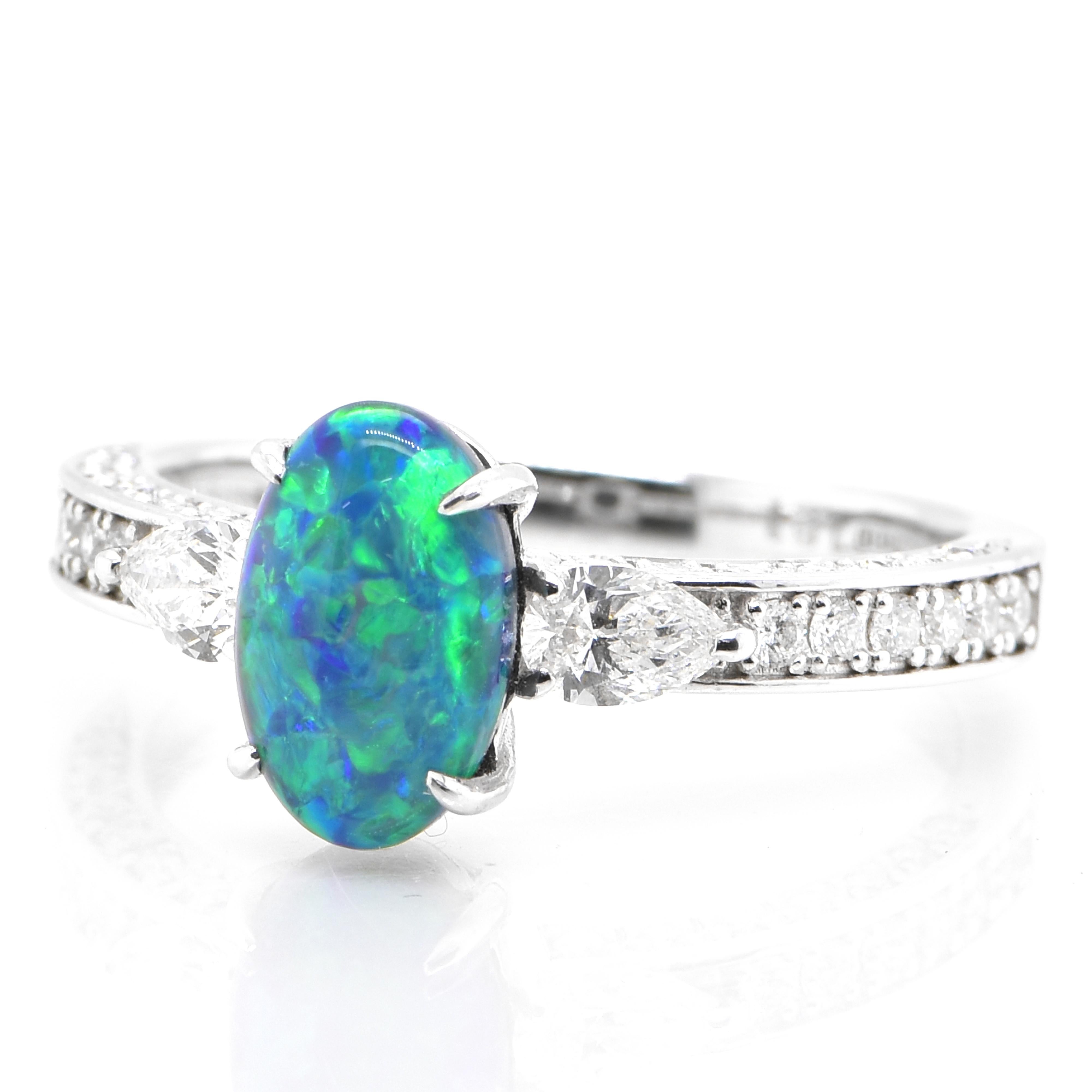 A beautiful ring featuring a 1.21 Carat, Natural, Australian Black Opal and 0.57 Carats of Diamond Accents set in Platinum. The Opal displays very good play of color! Opals are known for exhibiting flashes of rainbow colors known as 
