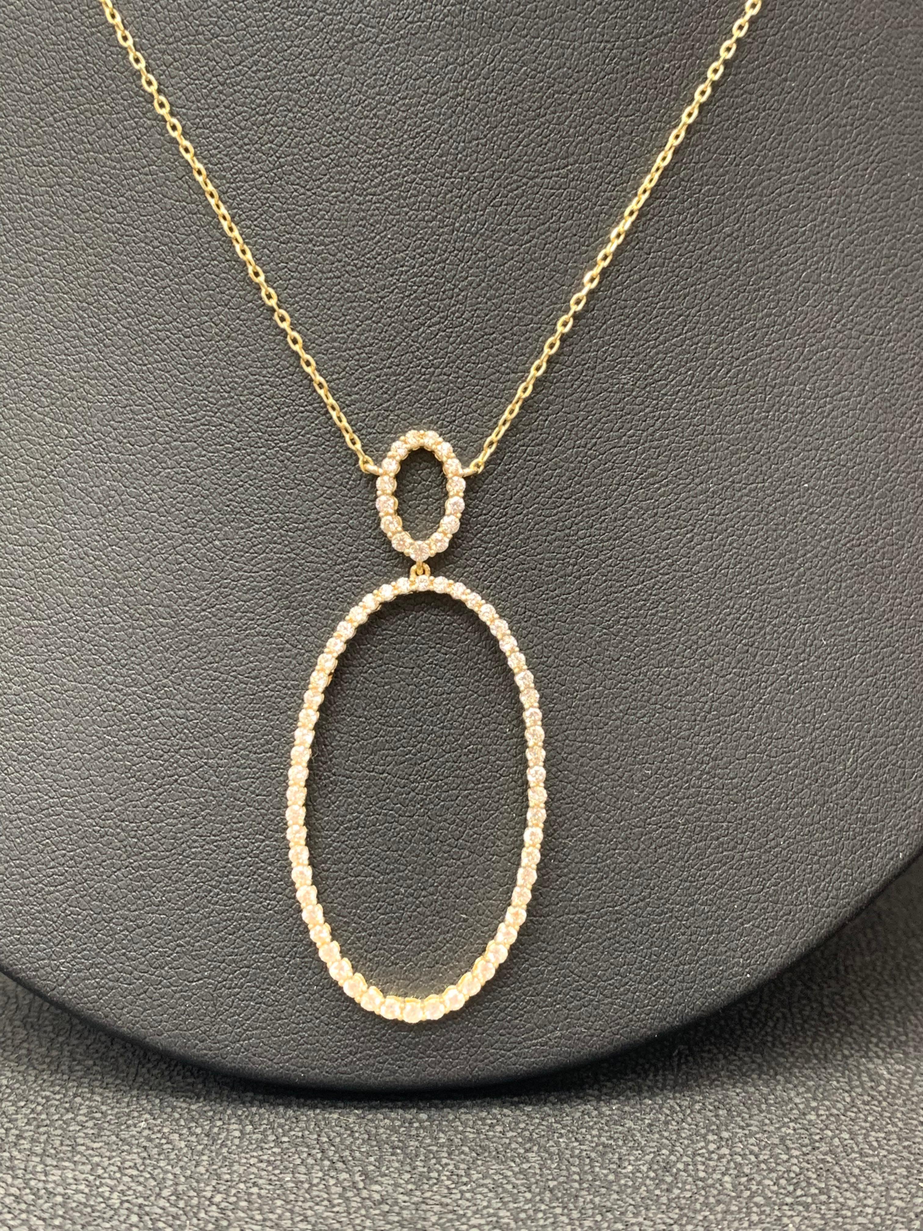 Features an open work oval design pendant accented with round brilliant diamonds. 69 Diamonds weigh 1.21 carats total. Made in 18K Yellow Gold. 18 inch chain.