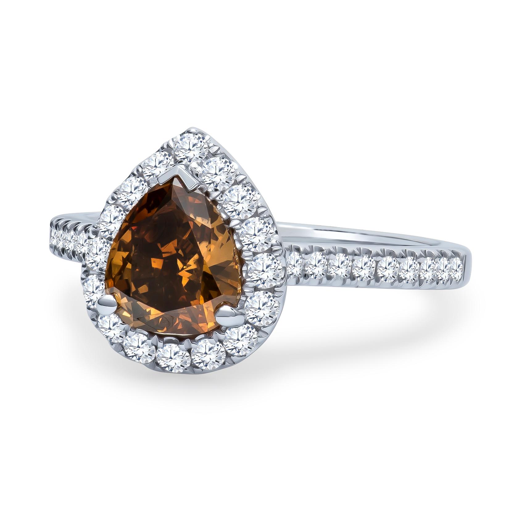 1.21 Carat pear shape fancy dark yellowish brown center diamond with 0.46 carats total weight of split prong-set round brilliant diamonds. In 18K white gold, size 6.5 and may be resized to larger or smaller upon request. 
Clarity: SI2

