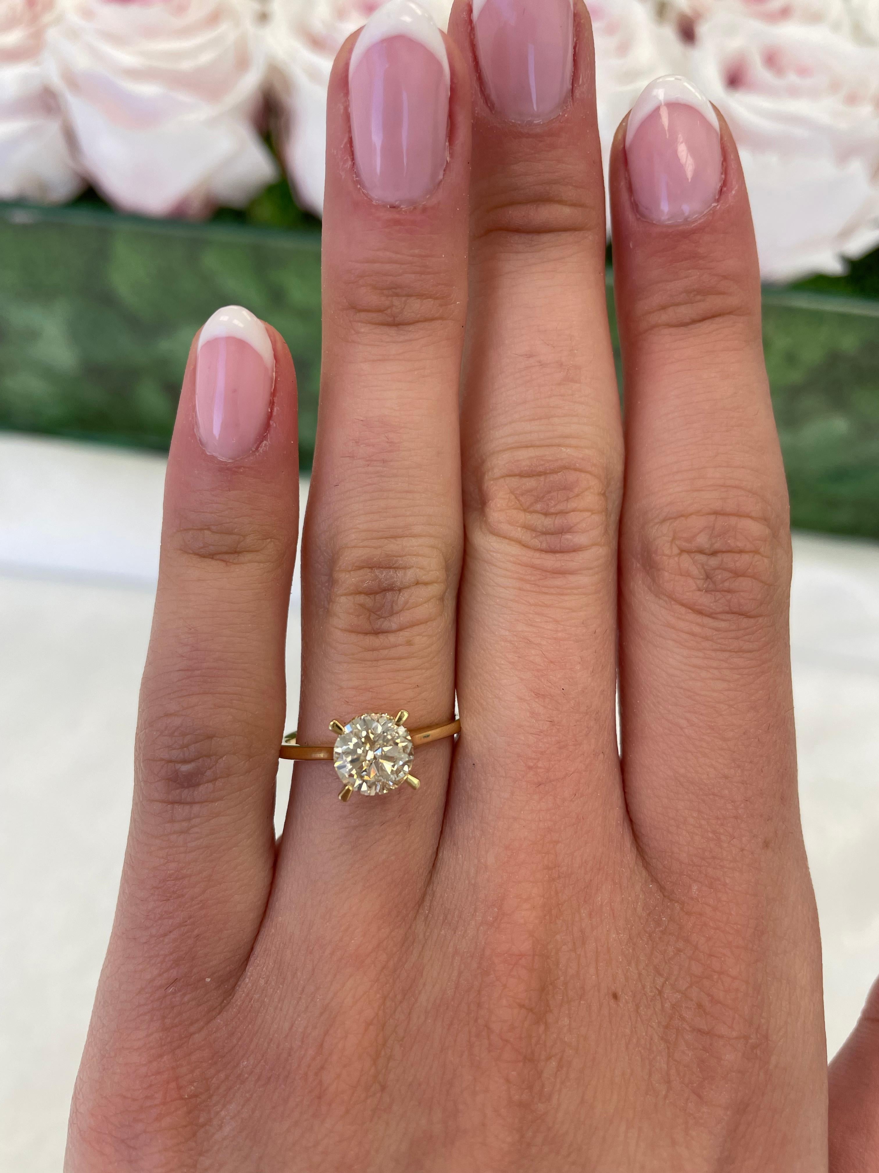 Classic solitaire diamond engagement ring with hidden halo.
1.43 carats total diamond weight.
1.21 carat round brilliant diamond, approximately I-K color grade and SI clarity grade. Complimented by 0.08 carats of round brilliant diamonds,