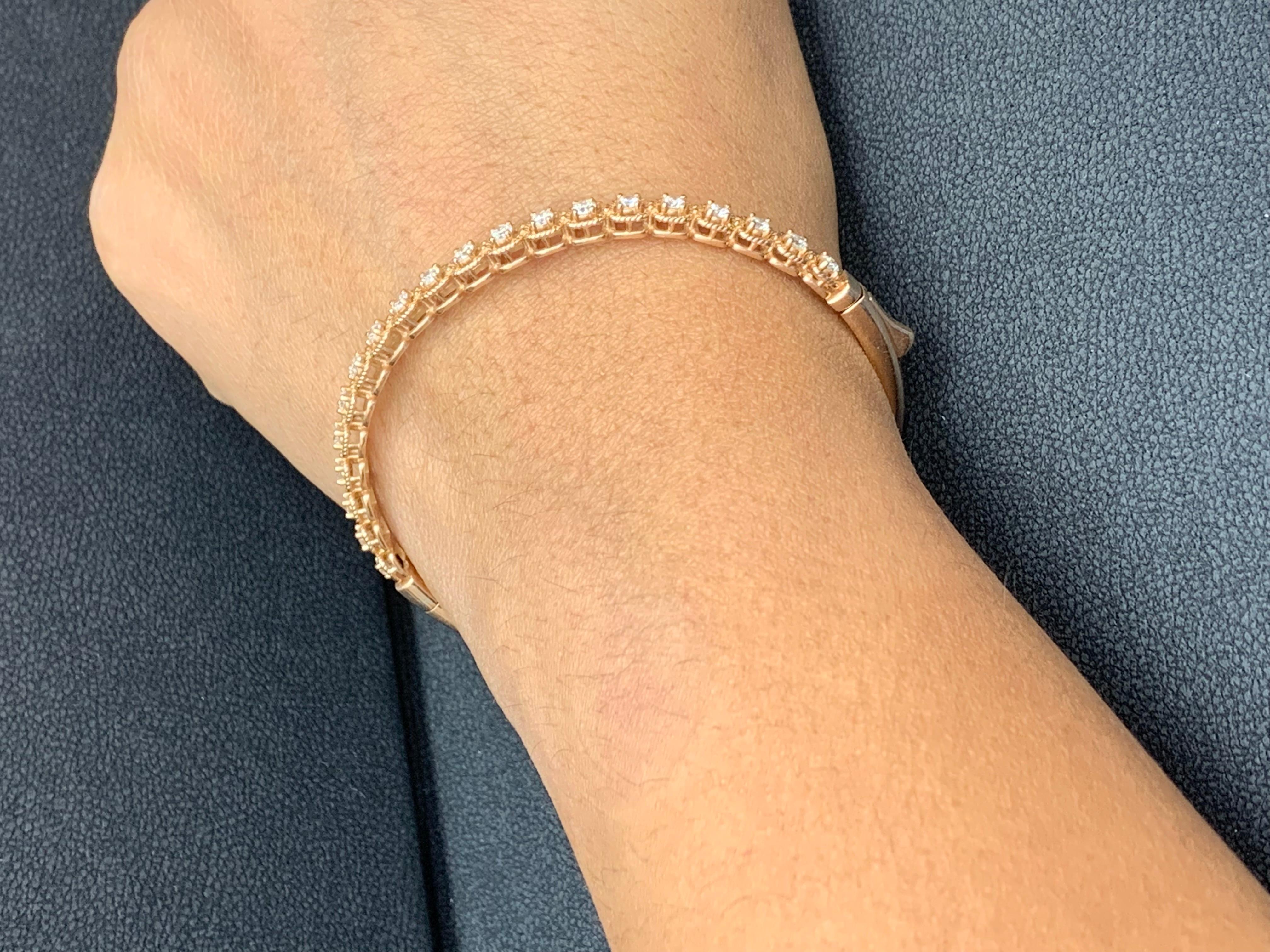 A stunning bangle bracelet set with 20 sparkling round diamonds weighing 1.21 carats total. Diamonds are set in rope design polished 14k rose gold. Double lock mechanism for maximum security. A simple yet dazzling piece.