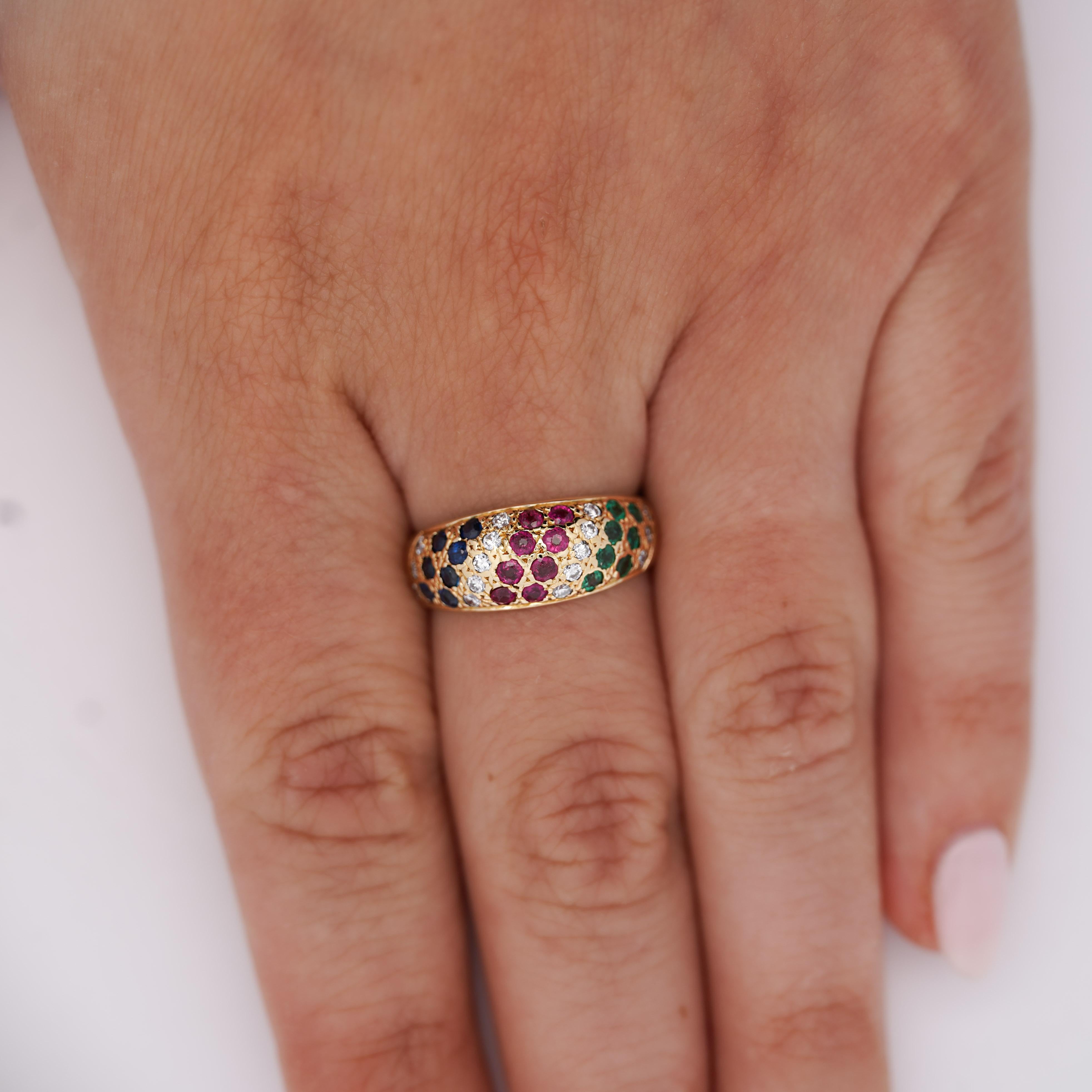 Bague dôme en or jaune 18 carats ornée de rubis, de saphirs, d'émeraudes et de diamants d'un poids total de 1,21 carat en serti clos. Le bracelet bombé mesure 8 mm de large pour un poids de 3,91 grammes, taille 7, réglable.

Spécifications du