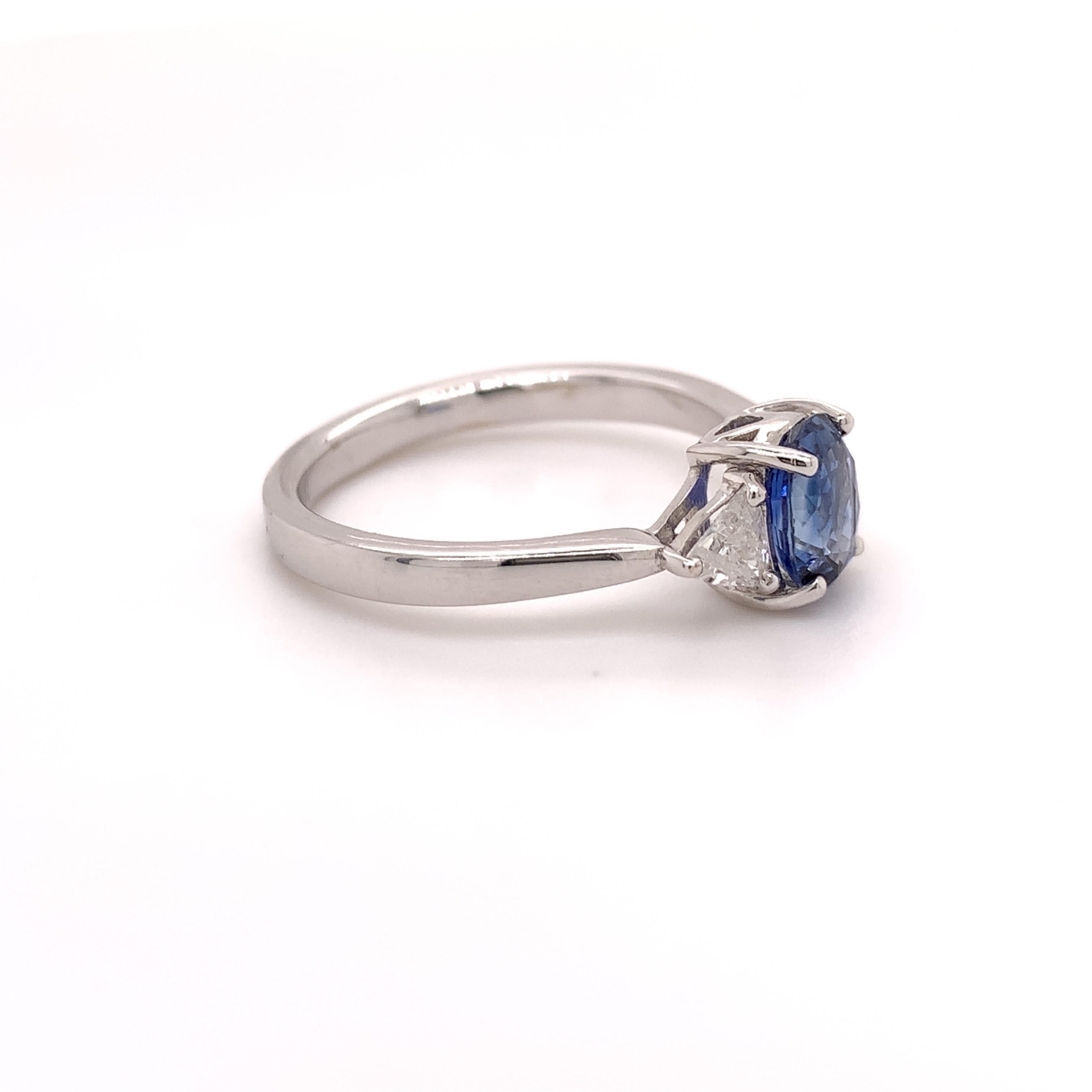 Ideal bridal sapphire diamond ring. Vibrant blue, oval faceted,  1.21 carats natural sapphire mounted in high profile with four bead prongs, accented with two triangles brilliant diamond. Handcrafted classic design set in 18 karats with gold.