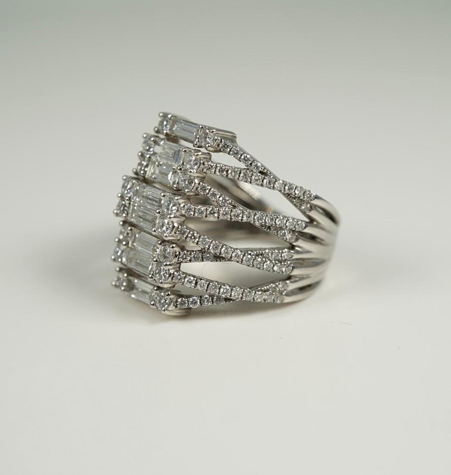 Such a statement piece!  In 14 karat white gold, this ring supports 1.21 carats of baguette and round diamonds!  It measures 19.00 mm x 19.00 mm across the top.